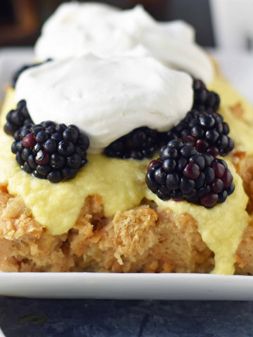 Blackberry Bread Pudding made with a warm brown sugar bread pudding topped with homemade creme anglaise sauce and fresh whipped cream. www.modernhoney.com
