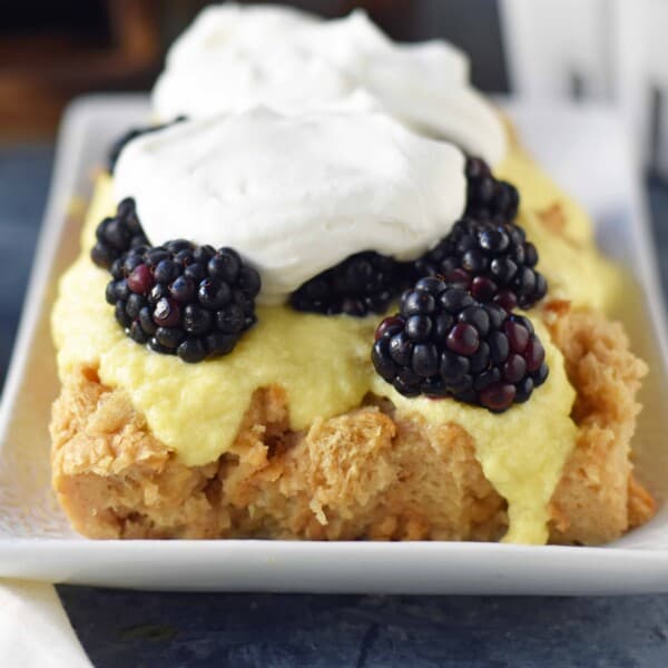 Blackberry Bread Pudding made with a warm brown sugar bread pudding topped with homemade creme anglaise sauce and fresh whipped cream. www.modernhoney.com