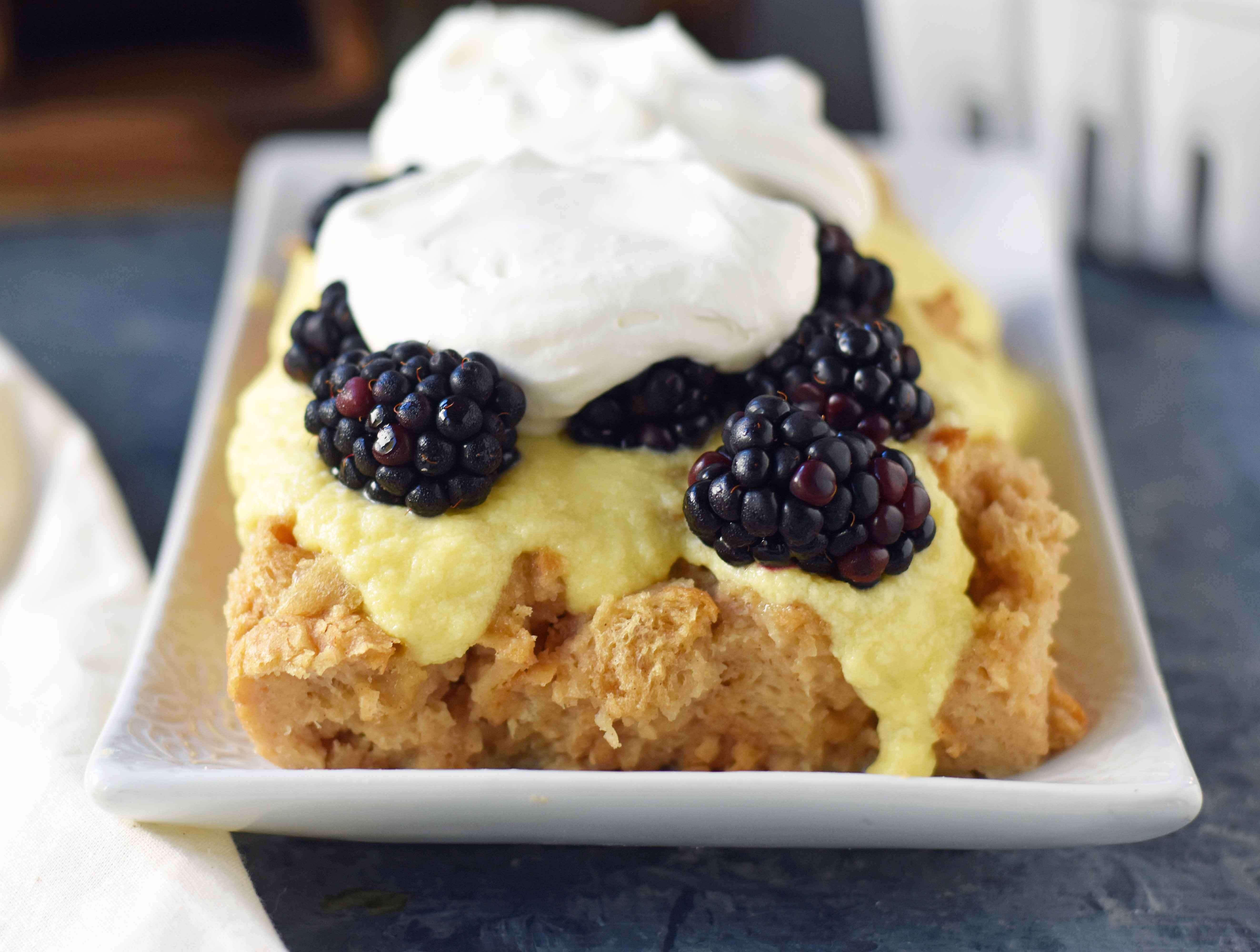 Blackberry Bread Pudding made with a warm brown sugar bread pudding topped with homemade creme anglaise sauce and fresh whipped cream. www.modernhoney.com