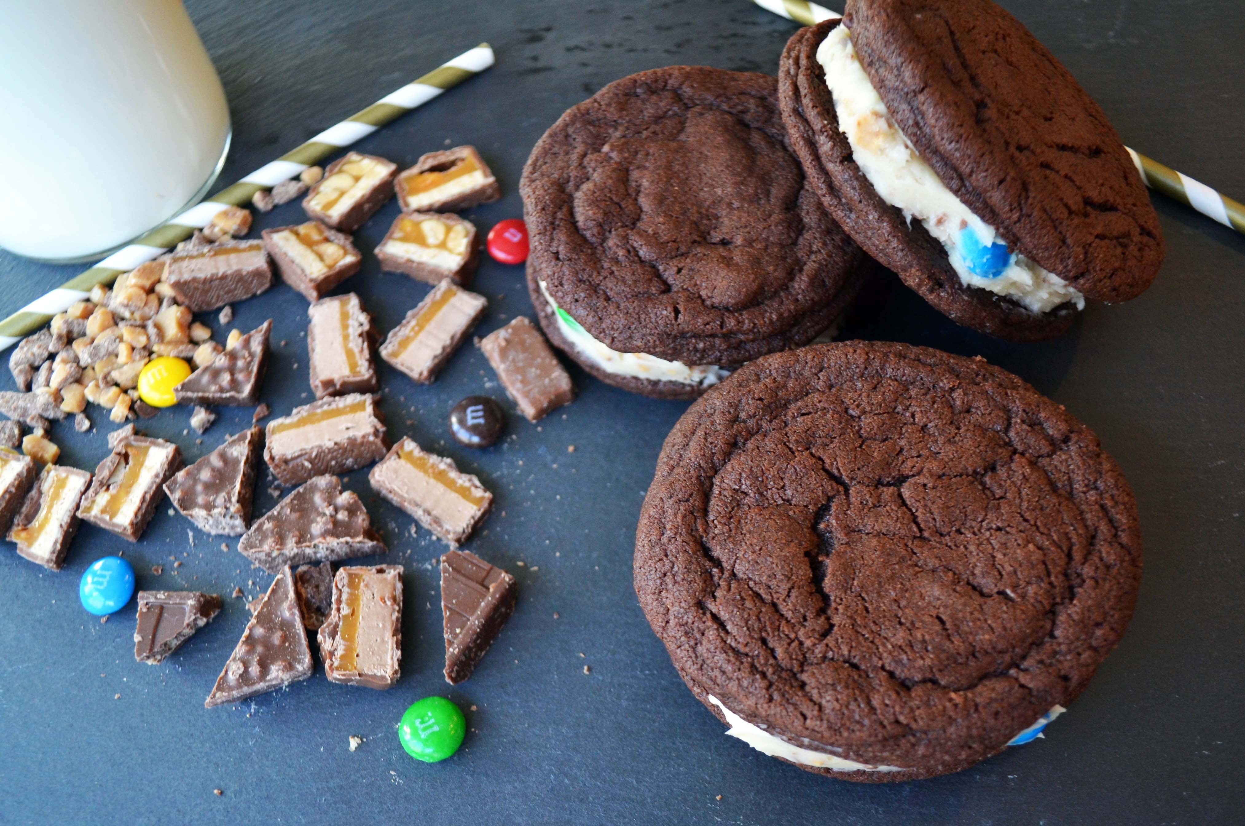 Oreo Stuffed Candy Monster Cookies. Homemade OREO cookies with a candy bar cream cheese filling. A soft chocolate cookie stuffed with a homemade filling made with cream cheese frosting and chocolate candy bars. A chocoholic's dream cookie! www.modernhoney.com