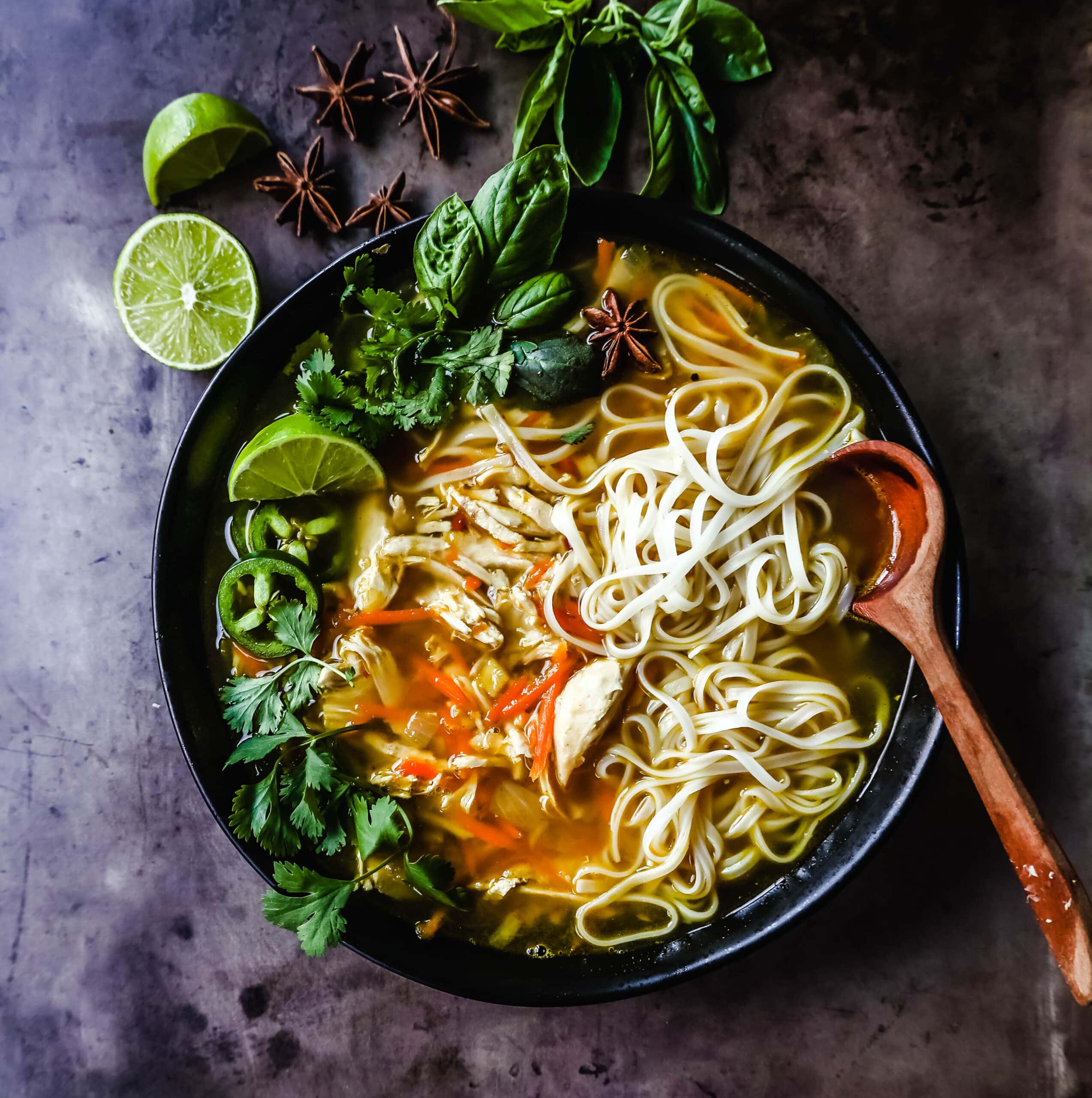 Quick and Easy Chicken Pho with tender chicken, warm broth, garlic, ginger, spices, fresh vegetables, and a touch of spice. This is a version of the popular Vietnamese Chicken Pho soup. 