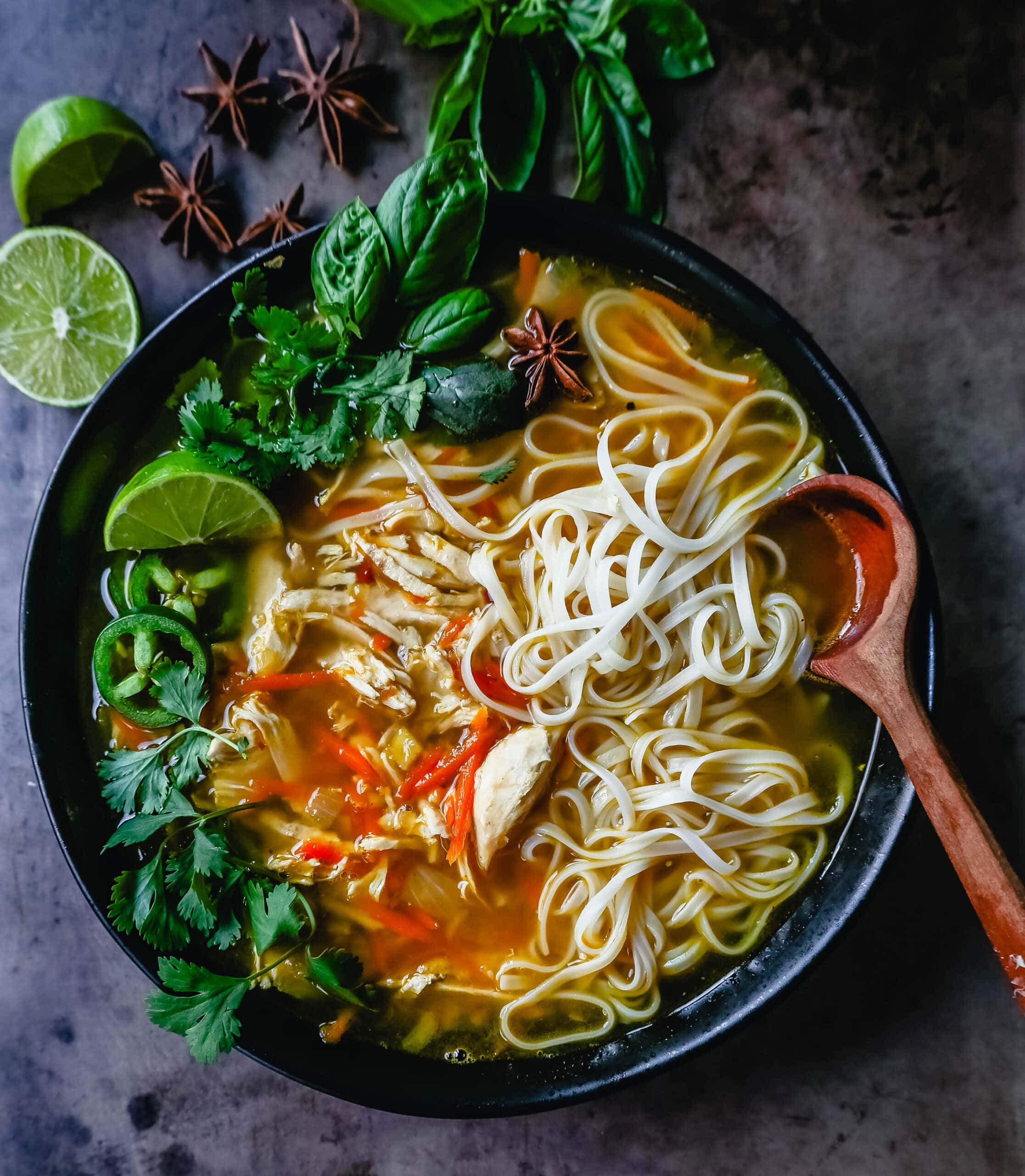 Quick and Easy Chicken Pho with tender chicken, warm broth, garlic, ginger, spices, fresh vegetables, and a touch of spice. This is a version of the popular Vietnamese Chicken Pho soup. 