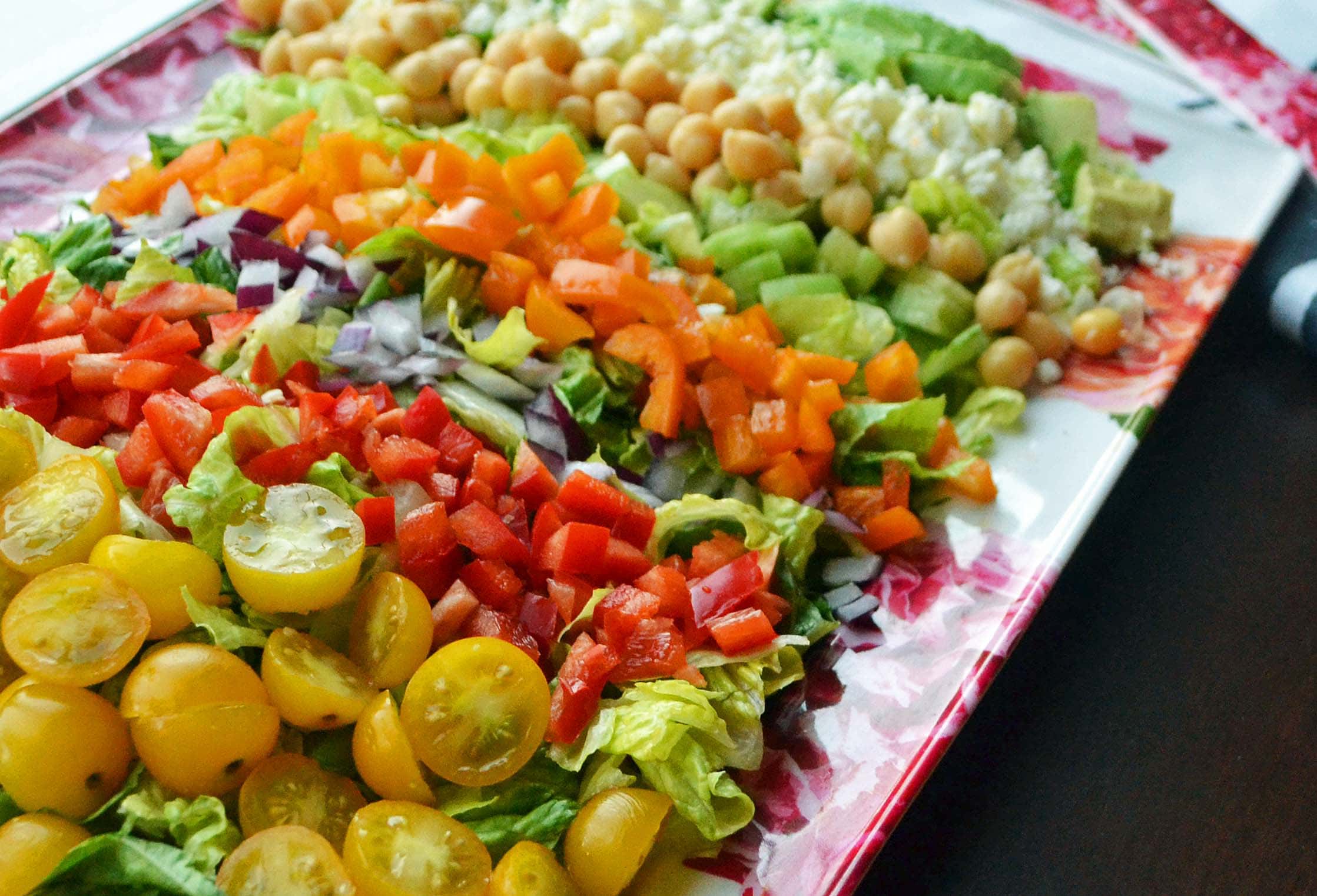 Greek Salad Recipe made with crisp vegetables, chickpeas, tangy feta cheese, creamy avocado, and a homemade Greek dressing. www.modernhoney.com