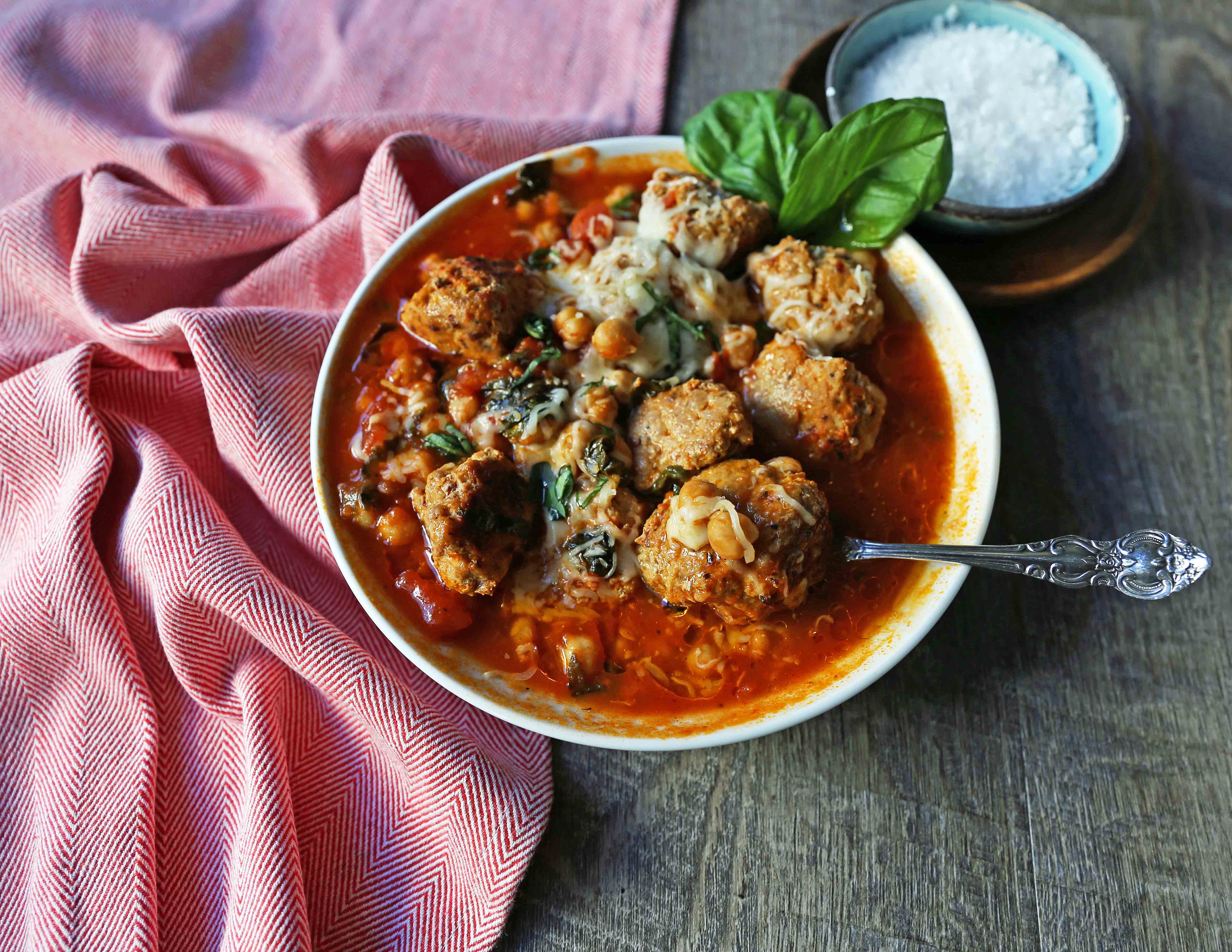 Healthy Spicy Turkey Meatball Soup A healthy soup made with lean turkey meatballs, spinach, chickpeas, marinara sauce, and parmesan cheese. Gluten-Free Turkey Meatball Soup. Low-carb soup recipe. www.modernhoney.com #turkeymeatballsoup #lowcarb #glutenfree #turkeymeatball