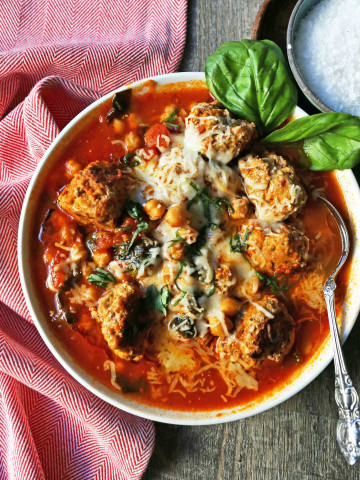 Healthy Spicy Turkey Meatball Soup A healthy soup made with lean turkey meatballs, spinach, chickpeas, marinara sauce, and parmesan cheese. Gluten-Free Turkey Meatball Soup. Low-carb soup recipe. www.modernhoney.com #turkeymeatballsoup #lowcarb #glutenfree #turkeymeatball