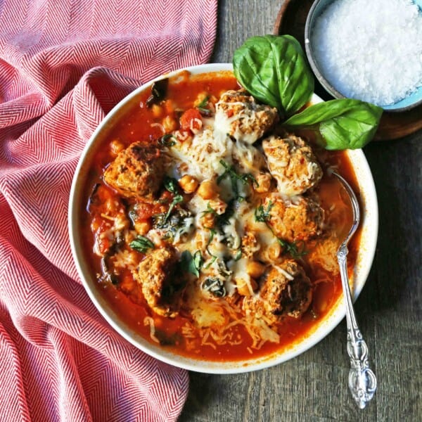 Healthy Spicy Turkey Meatball Soup A healthy soup made with lean turkey meatballs, spinach, chickpeas, marinara sauce, and parmesan cheese. Gluten-Free Turkey Meatball Soup. Low-carb soup recipe. www.modernhoney.com #turkeymeatballsoup #lowcarb #glutenfree #turkeymeatball