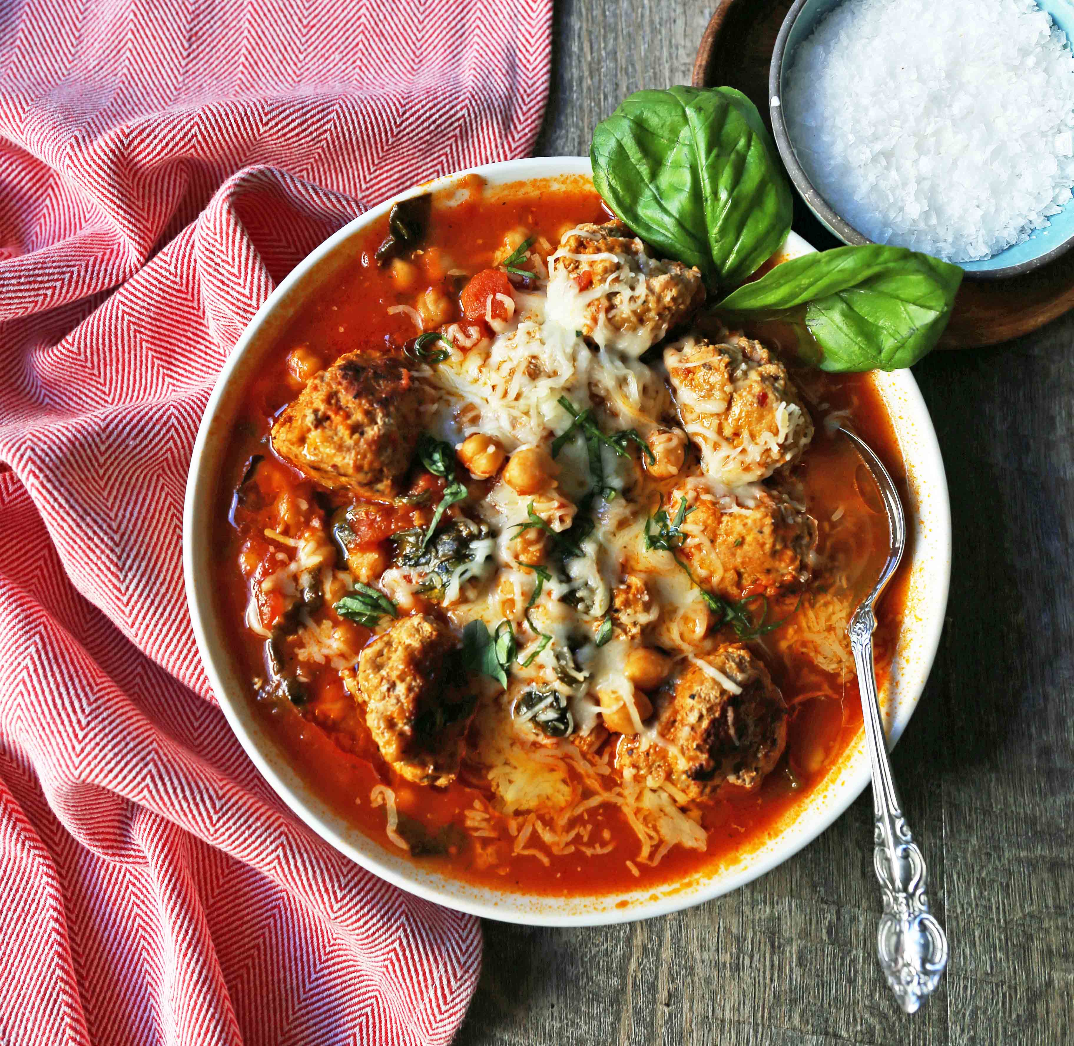 Healthy Spicy Turkey Meatball Soup A healthy soup made with lean turkey meatballs, spinach, chickpeas, marinara sauce, and parmesan cheese. Gluten-Free Turkey Meatball Soup. Low-carb soup recipe. www.modernhoney.com #turkeymeatballsoup #lowcarb #glutenfree #turkeymeatball