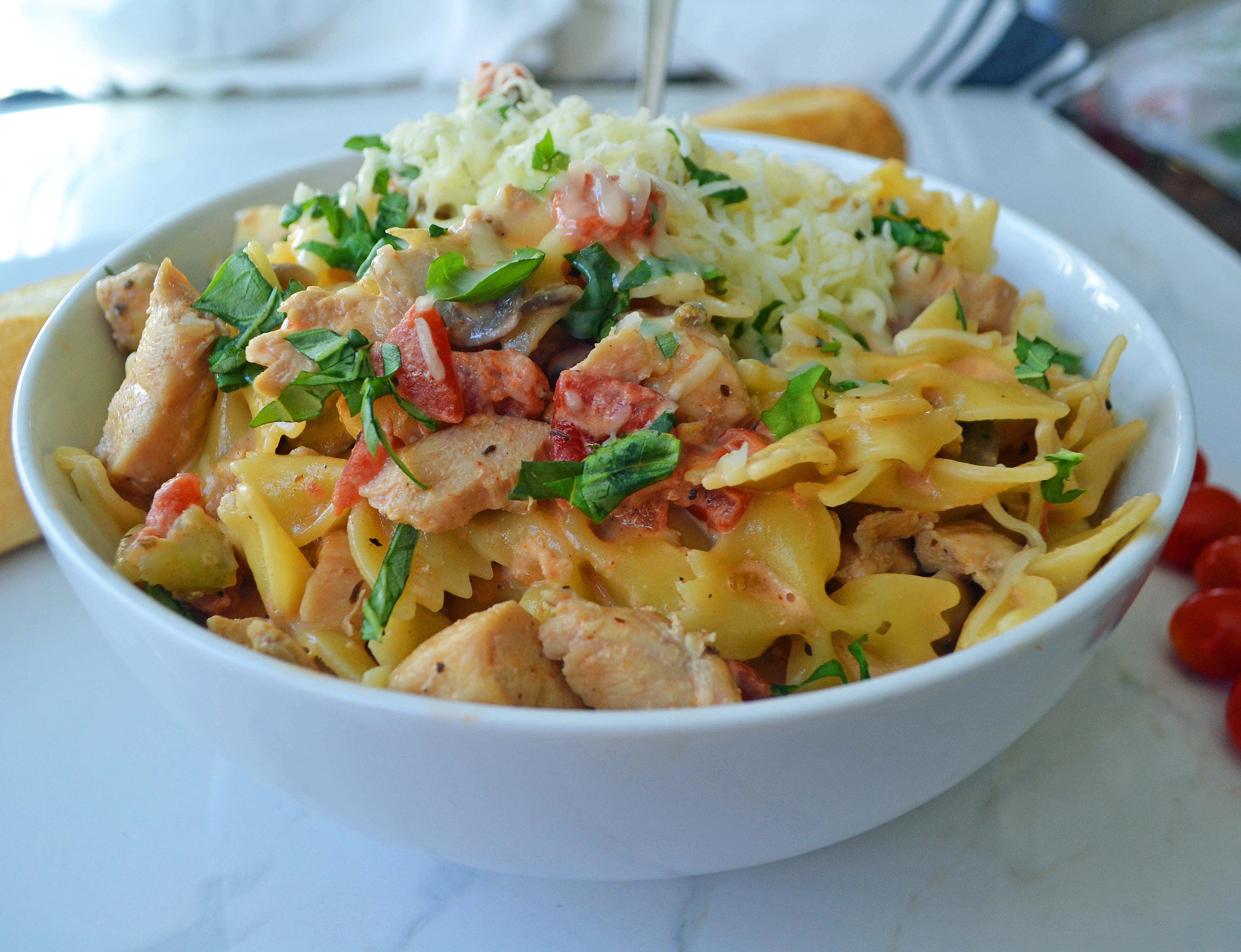 All Dressed Up Bowtie Chicken Pasta. Sauteed Chicken, Artichokes, Roasted Tomatoes, Heavy Cream, Fresh Basil, and Parmesan Cheese all tossed with Bowtie Pasta. Modern Honey - www.modernhoney.com