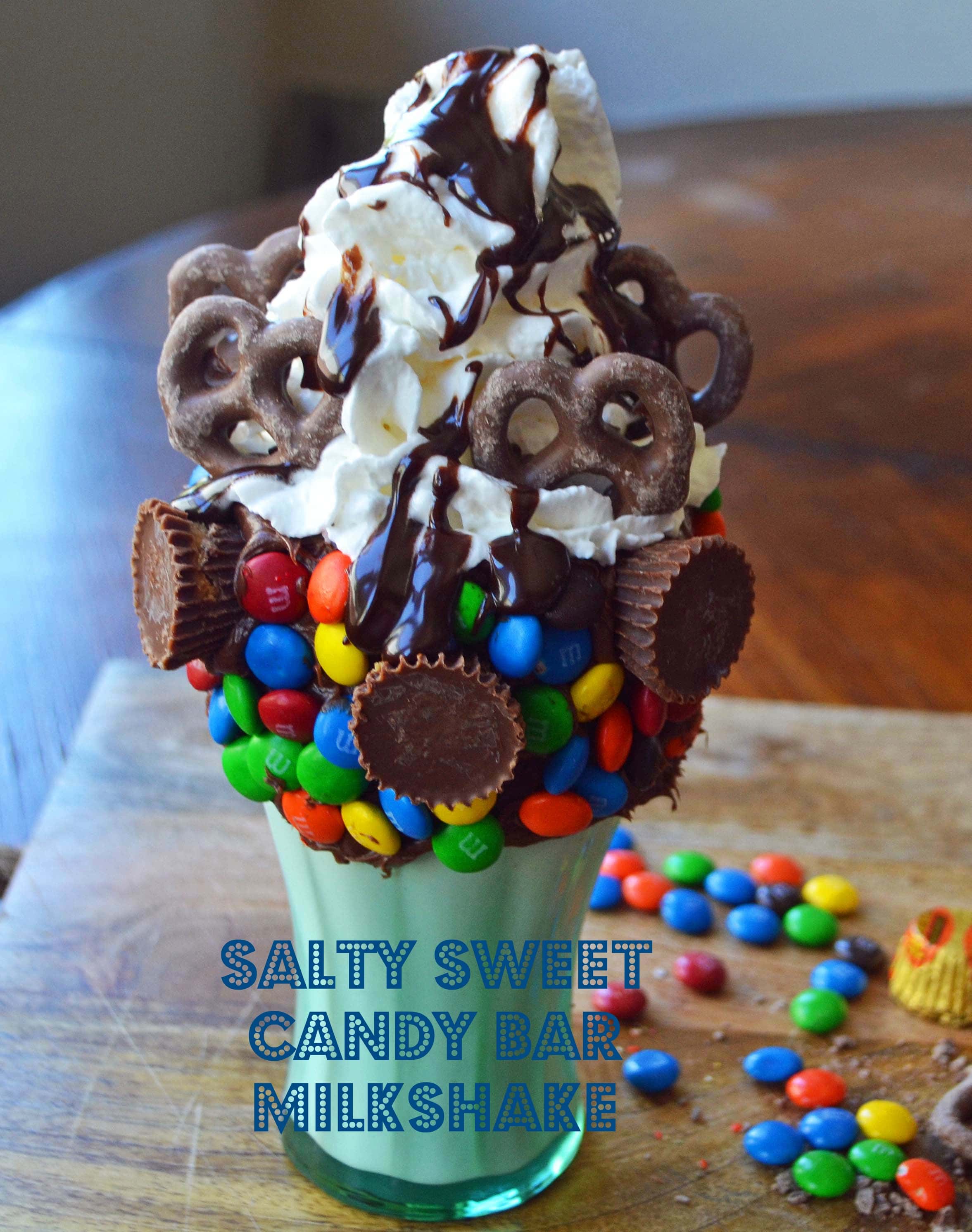 Black Tap Milkshakes Copycat Recipe. Salty Sweet Candy Bar Milkshake made with Vanilla Ice Cream, M & M's, Peanut Butter Cups, Chocolate Covered Pretzels, Hot Fudge, and Whipped Cream. www.modernhoney.com 