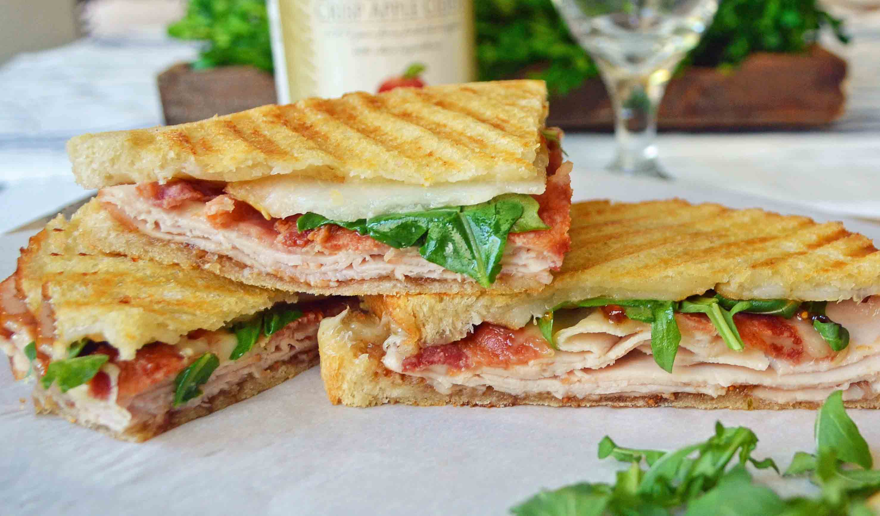 Turkey Bacon Panini with turkey, creamy havarti cheese, crispy bacon, fig spread, arugula, all on a buttered toasted bread. The perfect turkey bacon sandwich! www.modenrhoney.com