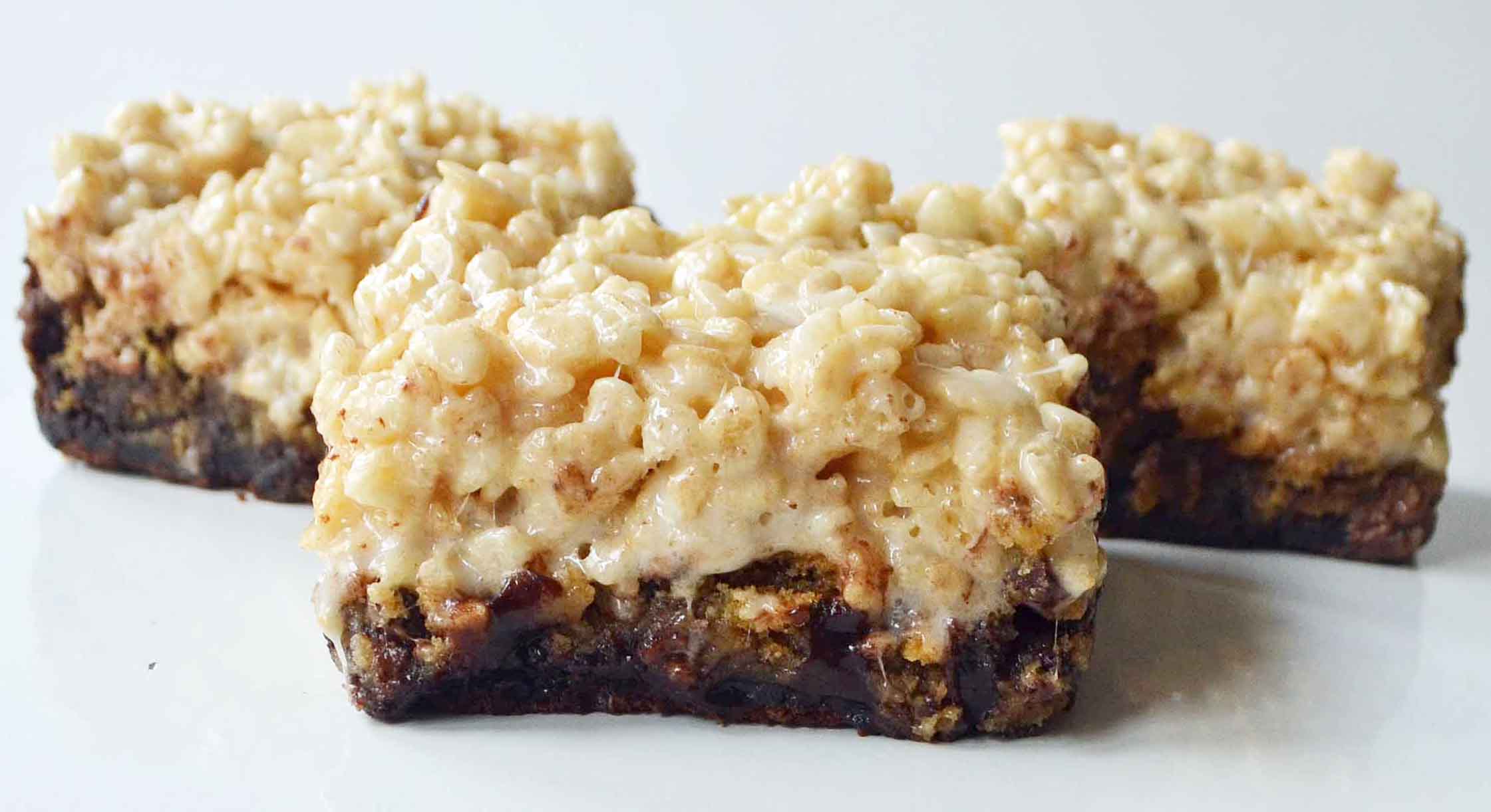 Bake Sale Trifecta Bars are a decadent chocolate brownie, classic chocolate chip cookies, and buttery soft rice krispies treat all in one. It is three favorite treats all in one bar! www.modernhoney.com