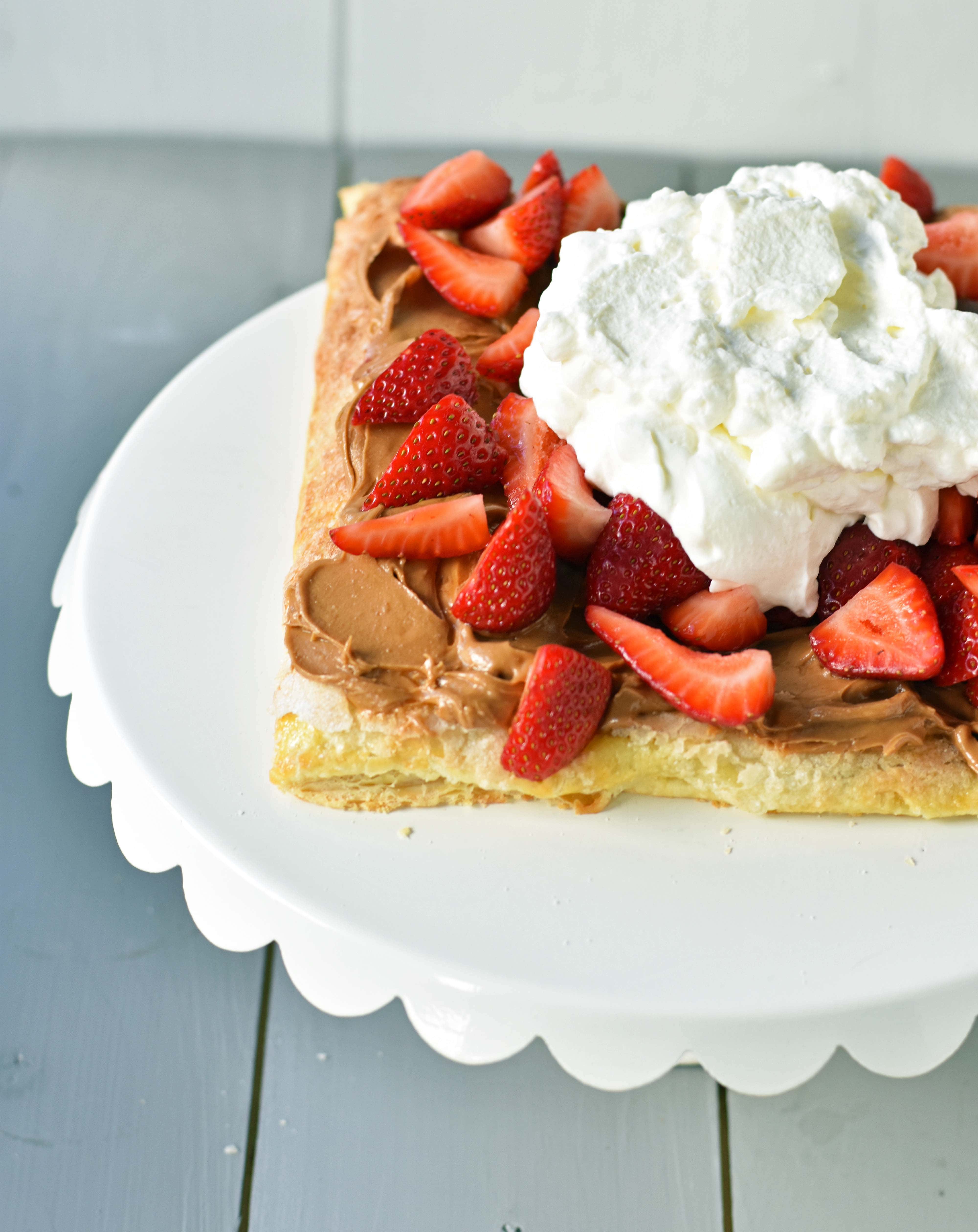 Lovebird Biscoff Cookie Butter Puff Pastry with fresh Strawberries. An easy dessert made with frozen puff pastry sprinkled with sugar and baked until golden. Topped with biscoff cookie butter and fresh strawberries. 