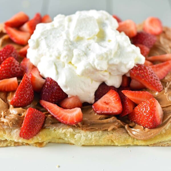 Lovebird Biscoff Cookie Butter Puff Pastry with fresh Strawberries. An easy dessert made with frozen puff pastry sprinkled with sugar and baked until golden. Topped with biscoff cookie butter and fresh strawberries.