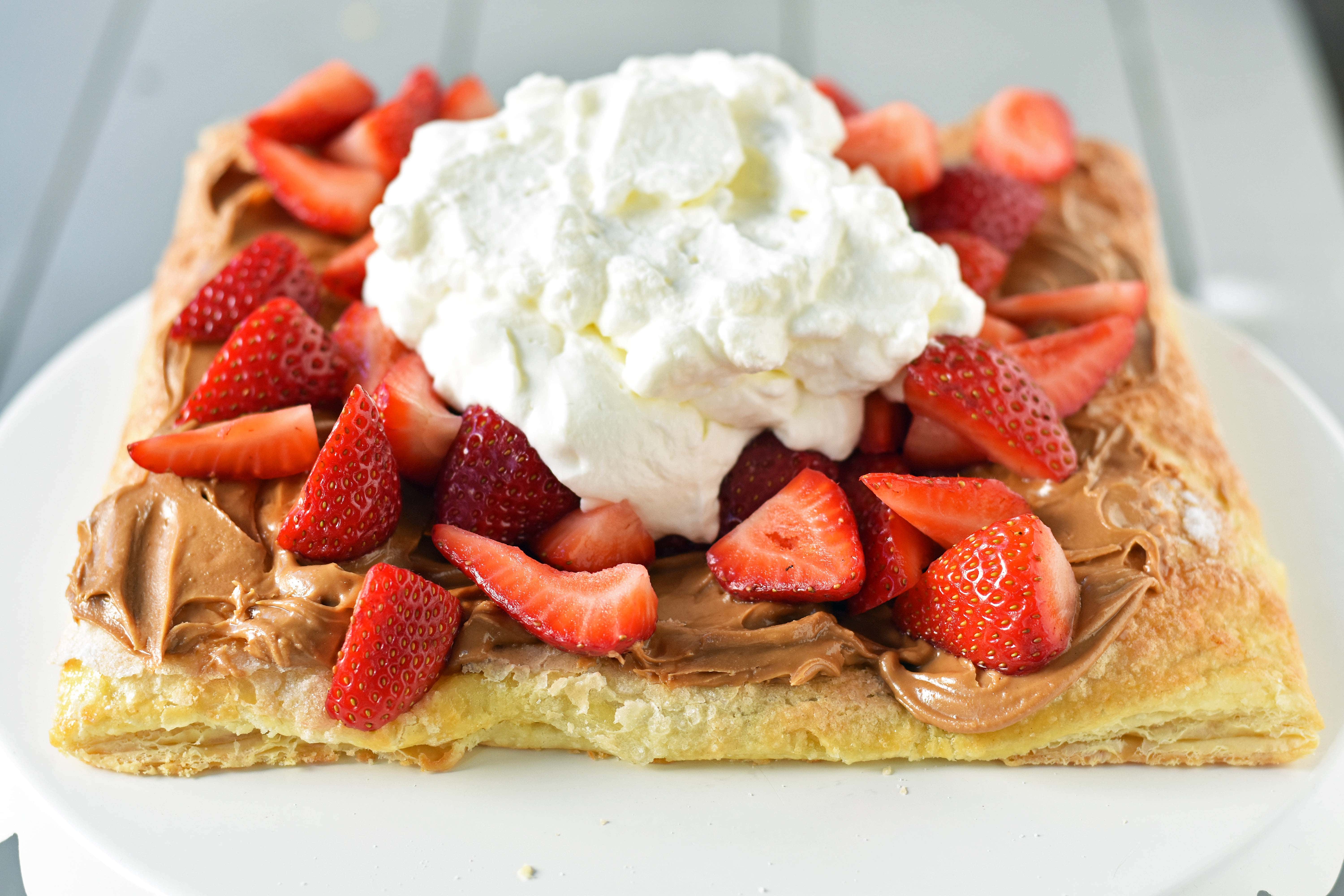 Lovebird Biscoff Cookie Butter Puff Pastry with fresh Strawberries. An easy dessert made with frozen puff pastry sprinkled with sugar and baked until golden. Topped with biscoff cookie butter and fresh strawberries. 