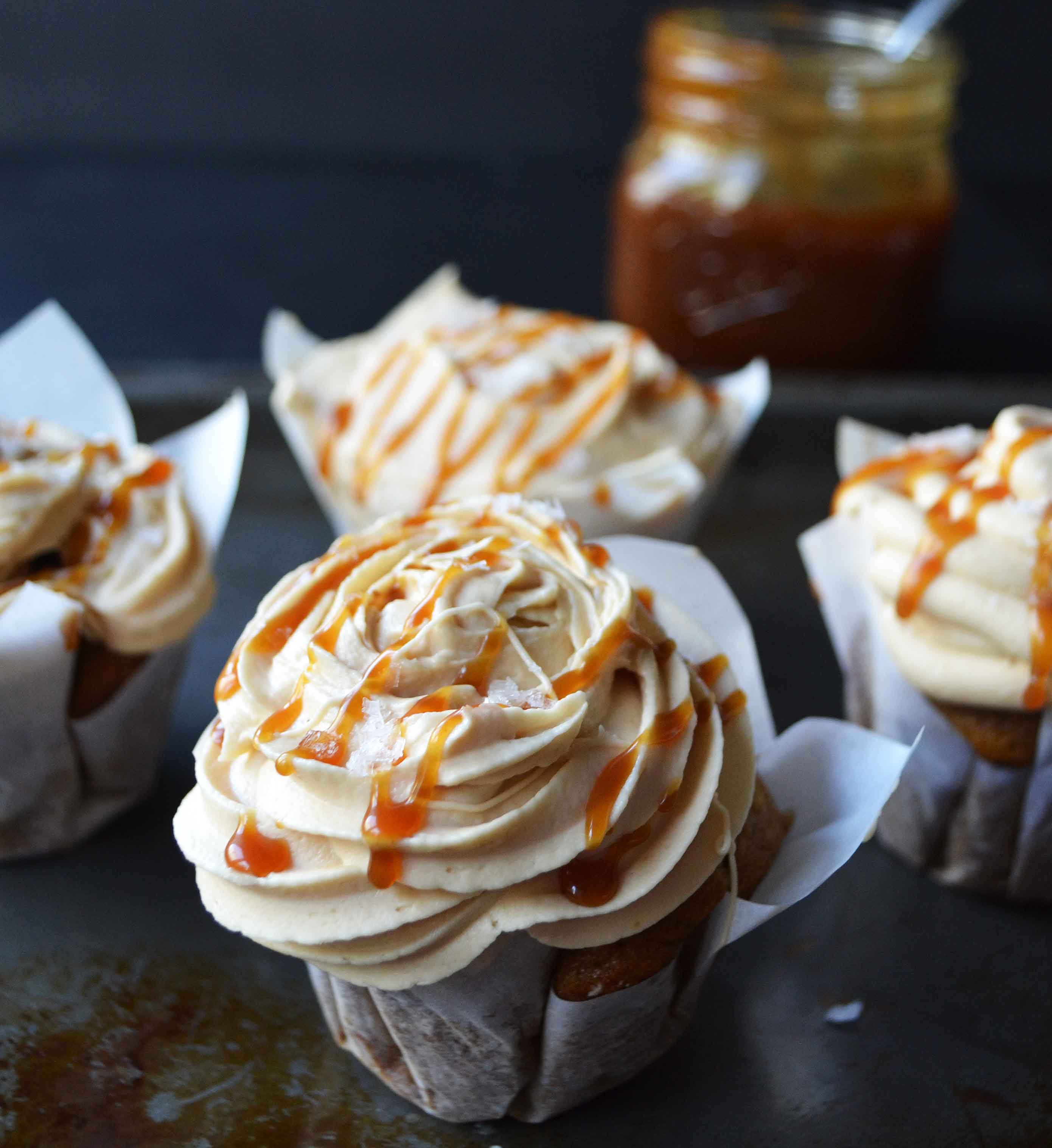 Pumpkin Cupcakes with Salted Caramel Frosting by Modern Honey. Homemade, made from scratch salted carmel frosting tops a cinnamon spiced pumpkin cupcake. The perfect Fall dessert! www.modernhoney.com