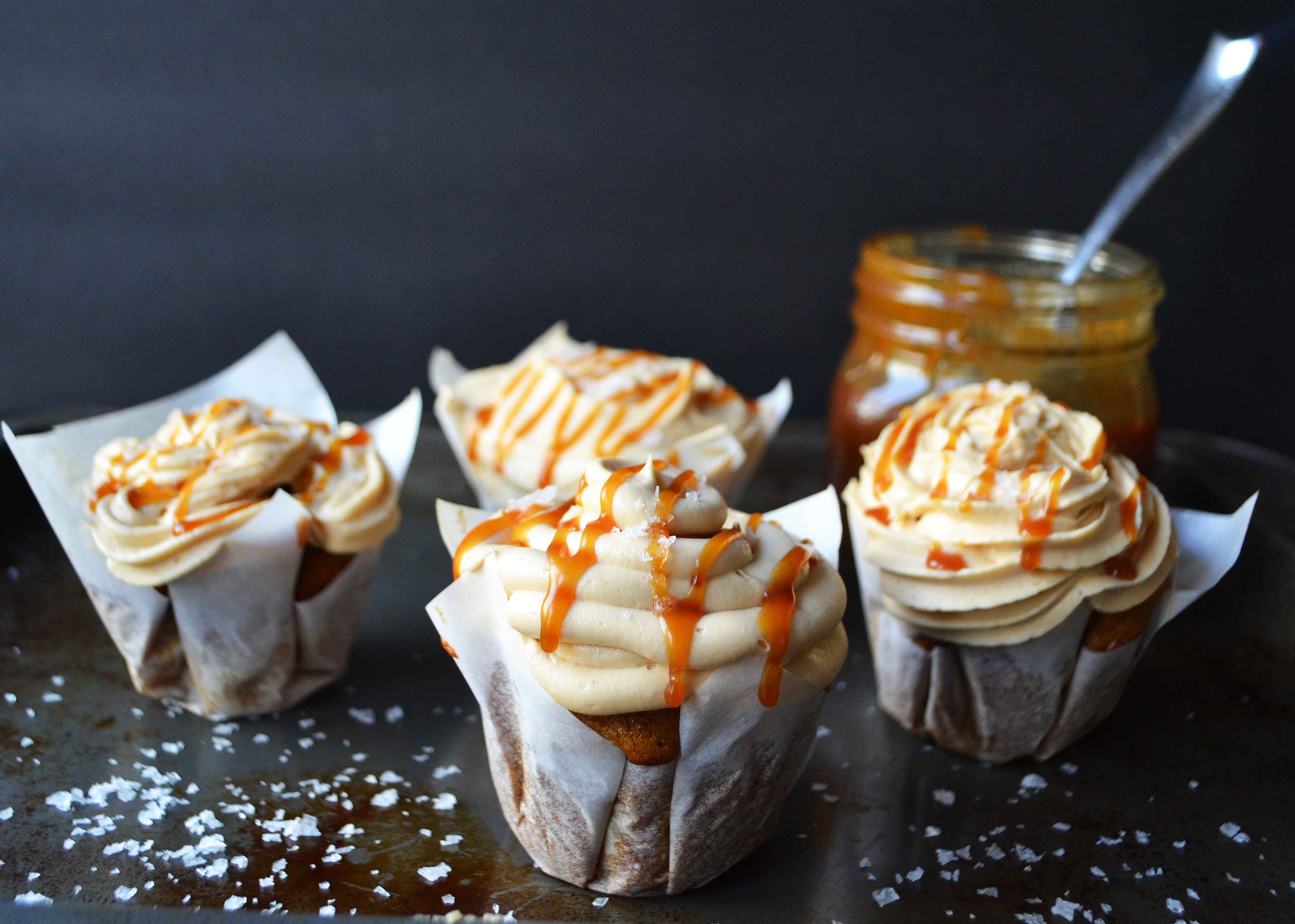 Pumpkin Cupcakes with Salted Caramel Frosting by Modern Honey. Homemade, made from scratch salted carmel frosting tops a cinnamon spiced pumpkin cupcake. The perfect Fall dessert! www.modernhoney.com