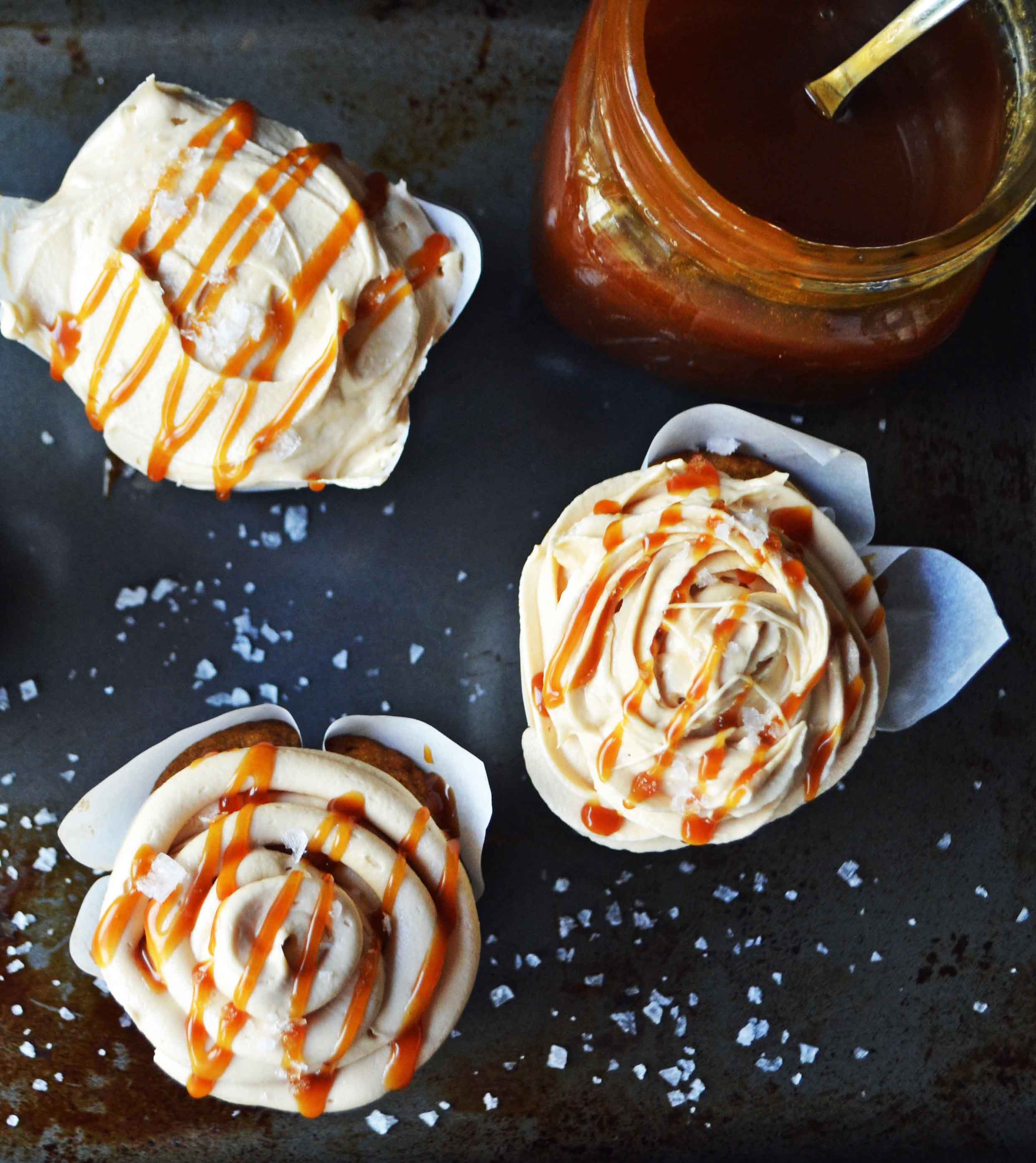 Pumpkin Cupcakes with Salted Caramel Frosting by Modern Honey. Homemade, made from scratch salted carmel frosting tops a cinnamon spiced pumpkin cupcake. The perfect Fall dessert! www.modernhoney.com