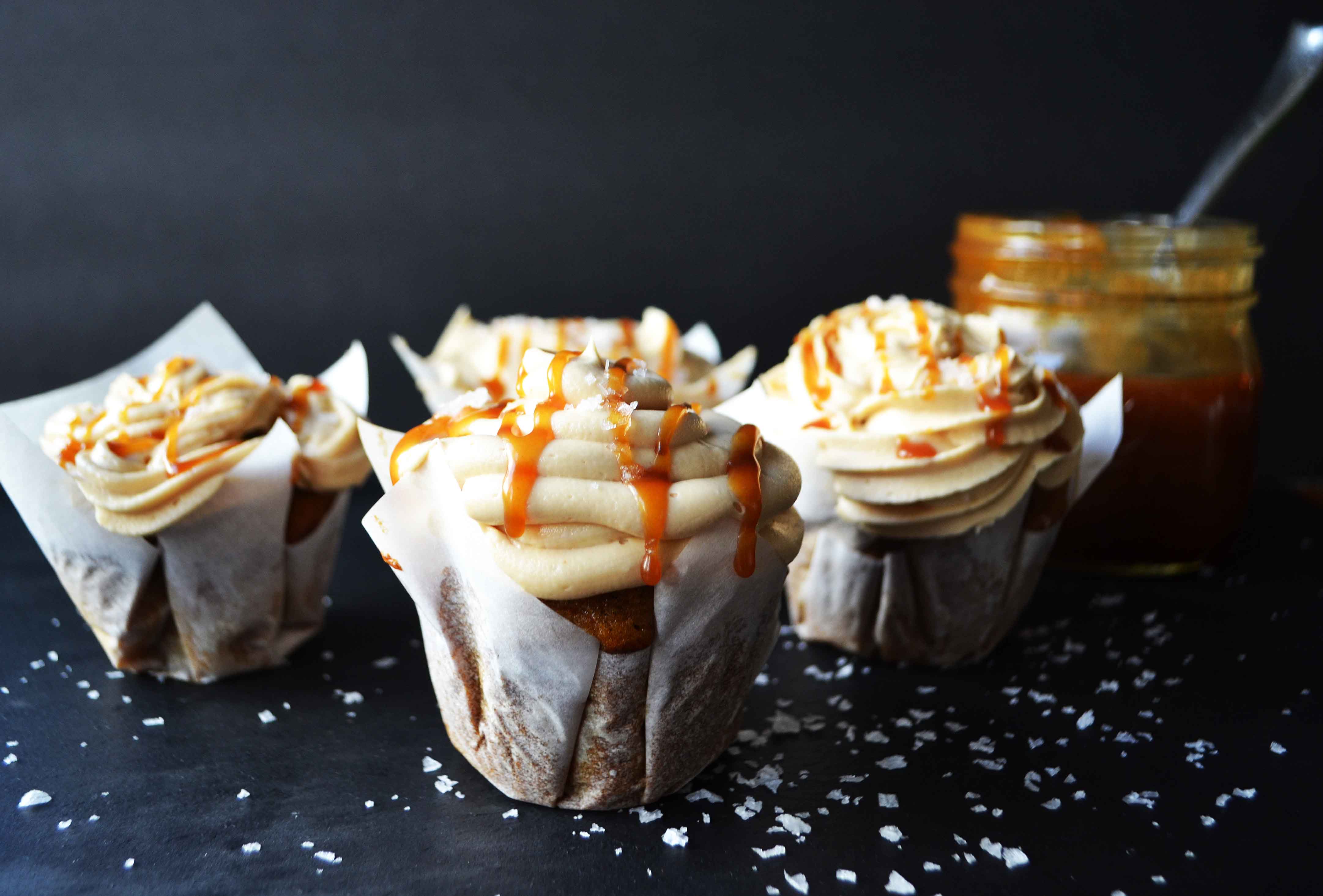 Pumpkin Cupcakes with Salted Caramel Frosting by Modern Honey. Homemade, made from scratch salted carmel frosting tops a cinnamon spiced pumpkin cupcake. The perfect Fall dessert! www.modernhoney.com