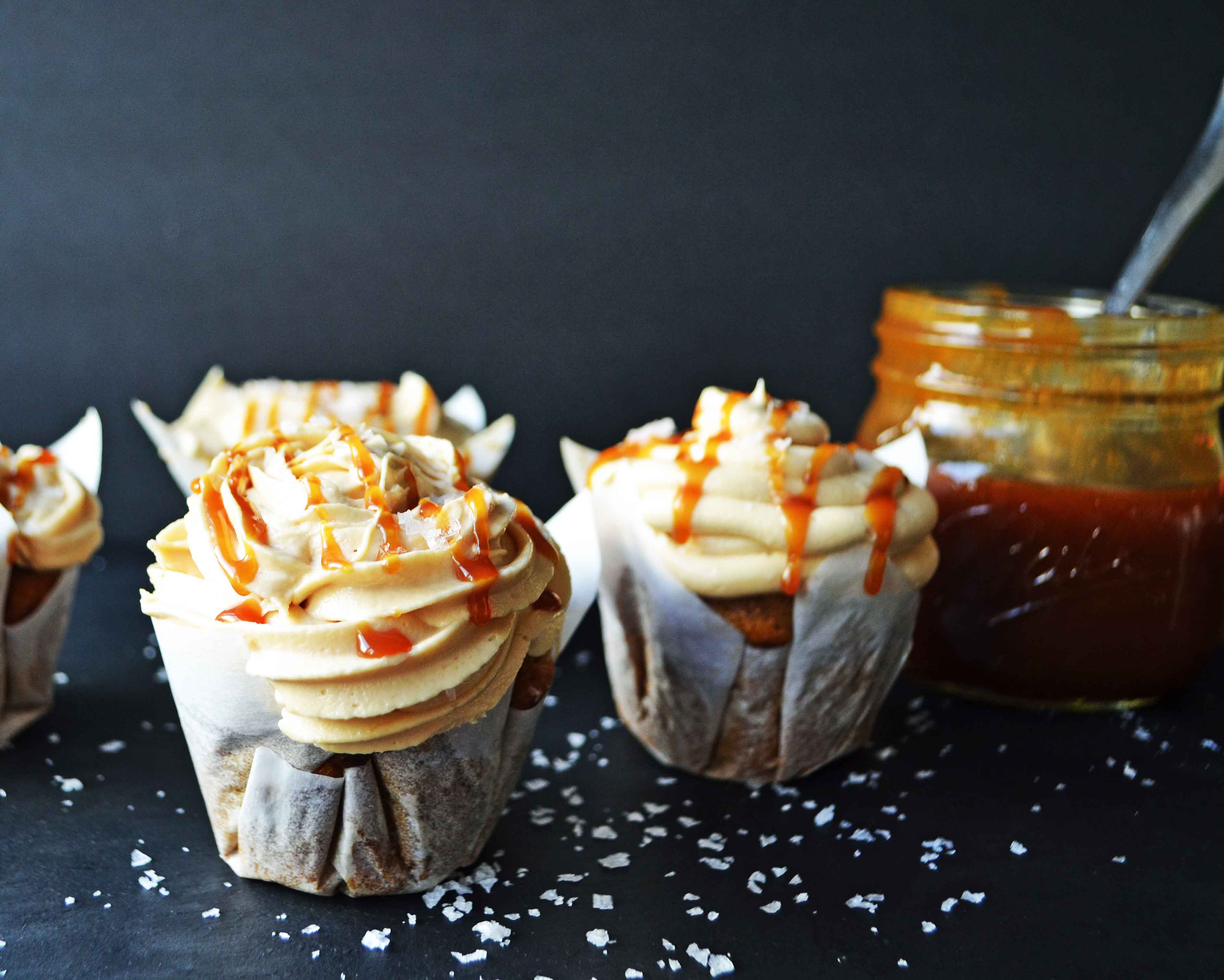 Pumpkin Cupcakes with Salted Caramel Frosting by Modern Honey. Homemade, made from scratch salted carmel frosting tops a cinnamon spiced pumpkin cupcake. The perfect Fall dessert! www.modernhoney.com