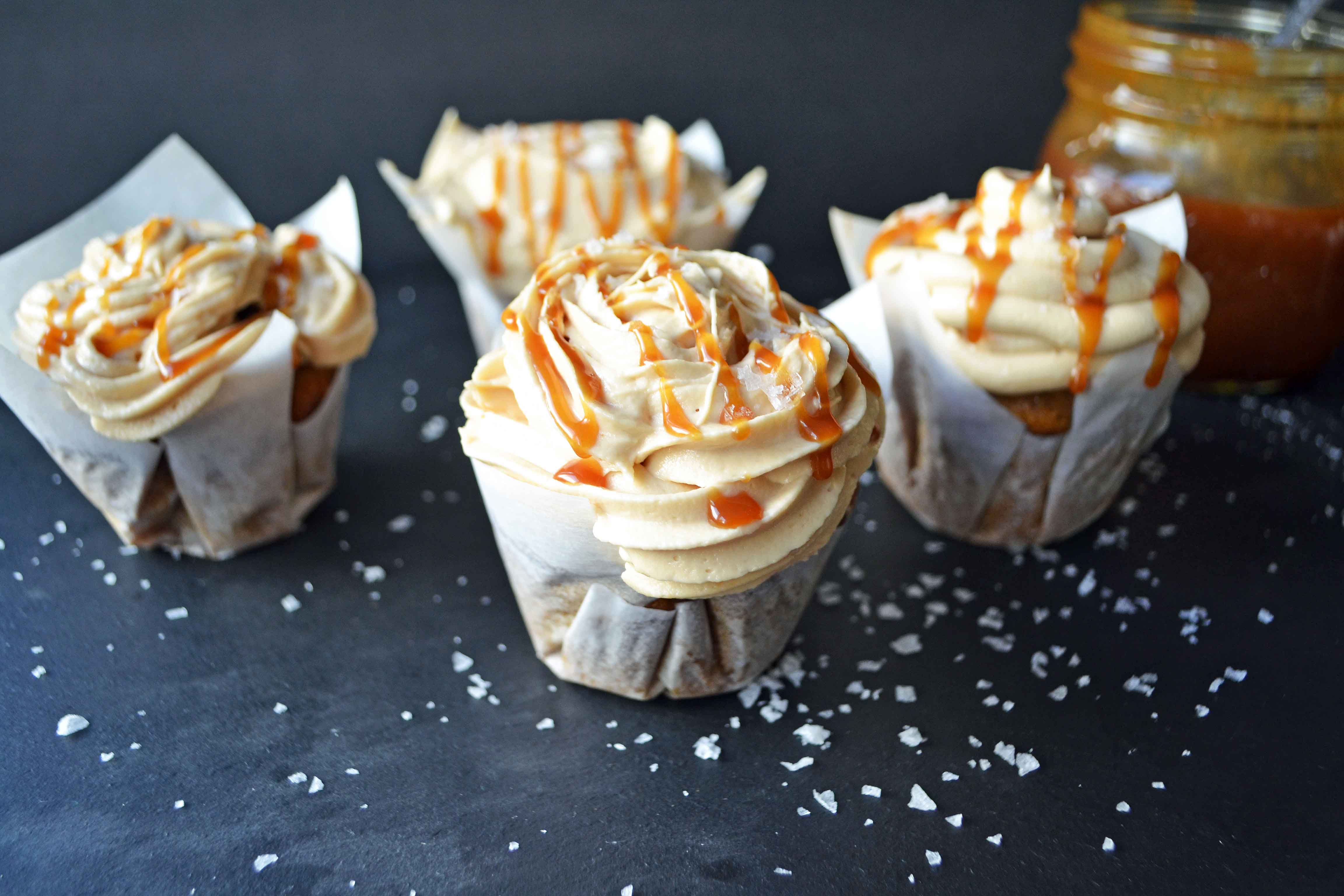 Pumpkin Cupcakes with Salted Caramel Frosting by Modern Honey. Homemade, made from scratch salted carmel frosting tops a cinnamon spiced pumpkin cupcake. The perfect Fall dessert! www.modernhoney.com