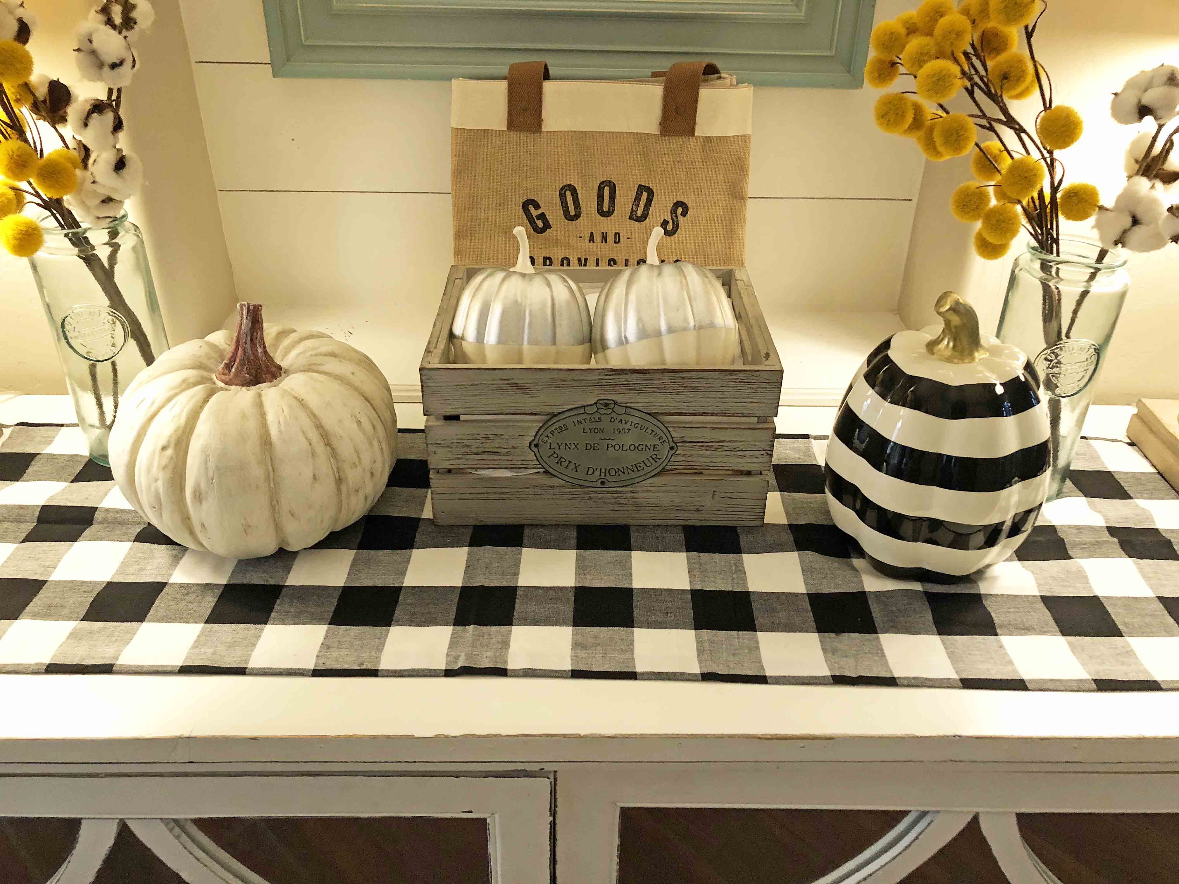 Light and Bright Fall Decor Ideas for the Entry. How to decorate your home for Fall. Black and White Checkered Buffalo Plaid Table Runner. White Pumpkins and Black and White Striped Pumpkins. www.modernhoney.com #buffaloplaidrunner #buffaloplaid #buffalocheck #falldecor #falldecorideas #falldecorations #whiteFalldecor