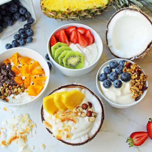 Greek Yogurt Breakfast Bowls with Toppings by Modern Honey. Healthy Greek Yogurt topped with fresh fruits, nuts, and honey. It's a perfect breakfast to start the day!
