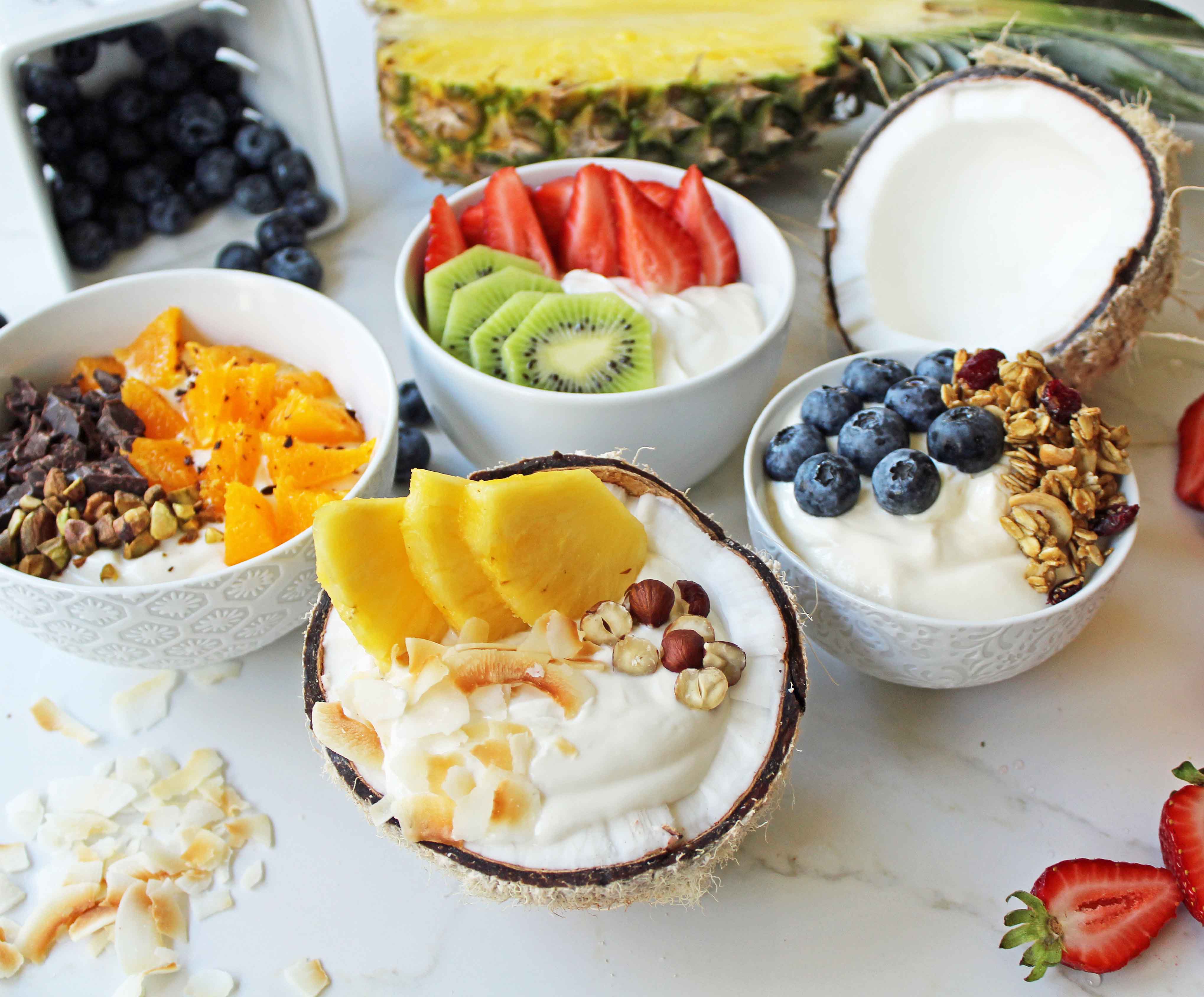 Greek Yogurt Breakfast Bowls with Toppings by Modern Honey. Healthy Greek Yogurt topped with fresh fruits, nuts, and honey. It's a perfect breakfast to start the day!