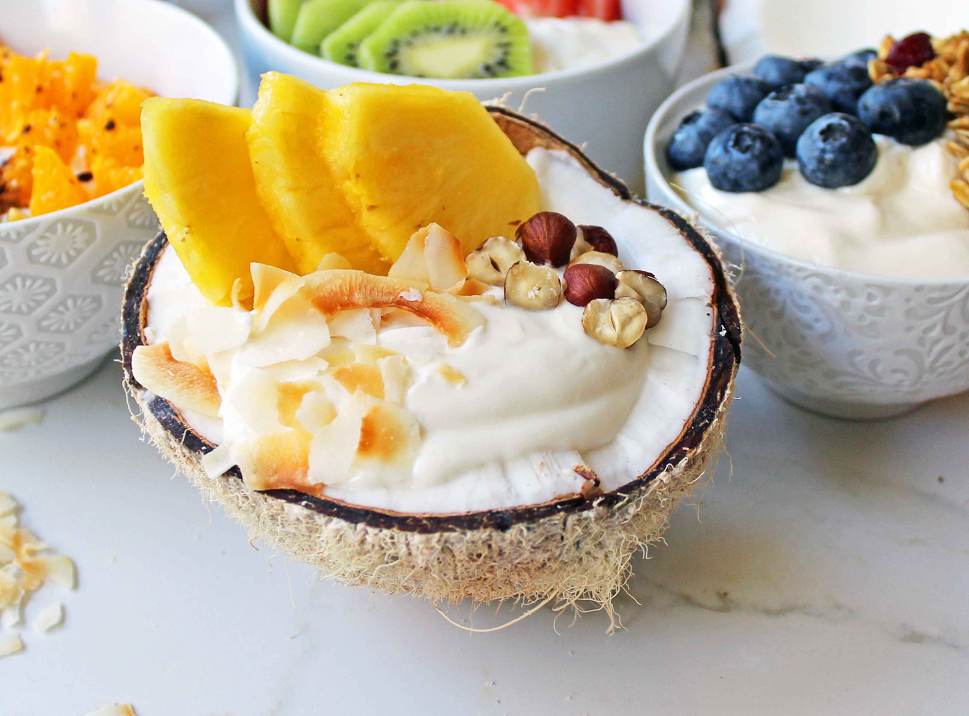 Greek Yogurt Breakfast Bowls with Toppings by Modern Honey. Healthy Greek Yogurt topped with fresh fruits, nuts, and honey. It's a perfect breakfast to start the day!