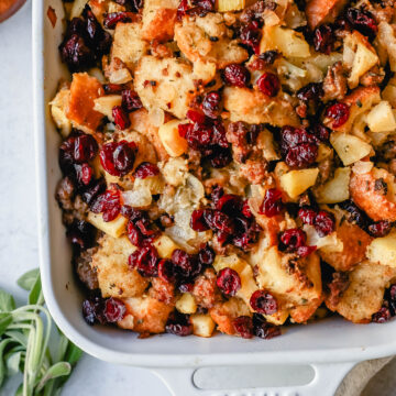 Classic Sausage Herb Stuffing with Fresh Apples and Cranberries make this the most savory Thanksgiving stuffing recipe. This Homemade Sausage Stuffing is the perfect Thanksgiving side dish recipe.