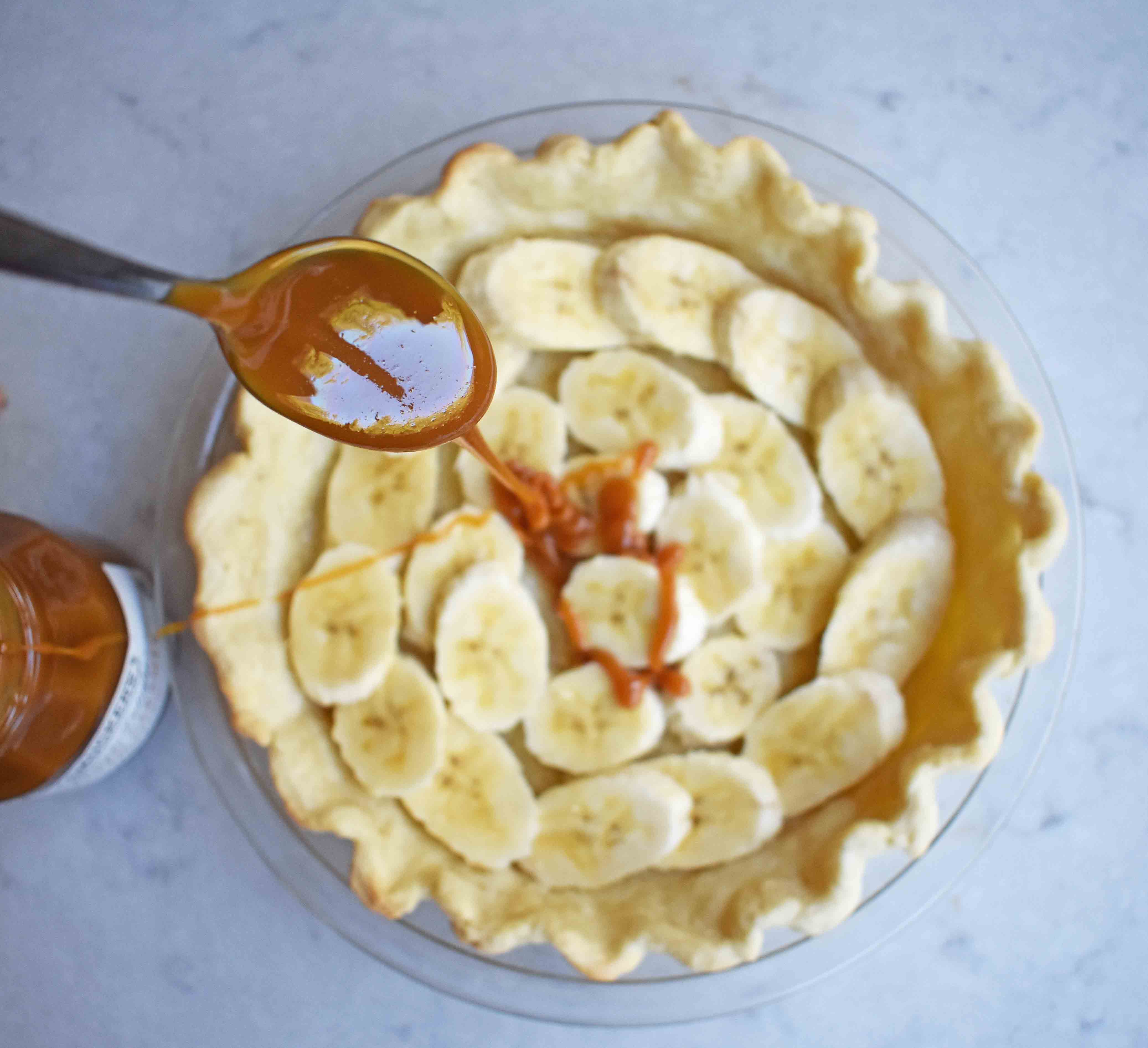 Salted Caramel Banana Cream Pie. Sweet Homemade Custard topped with fresh bananas, handcrafted salted caramel, and sweetened whipped cream all on a flaky, buttery crust. 