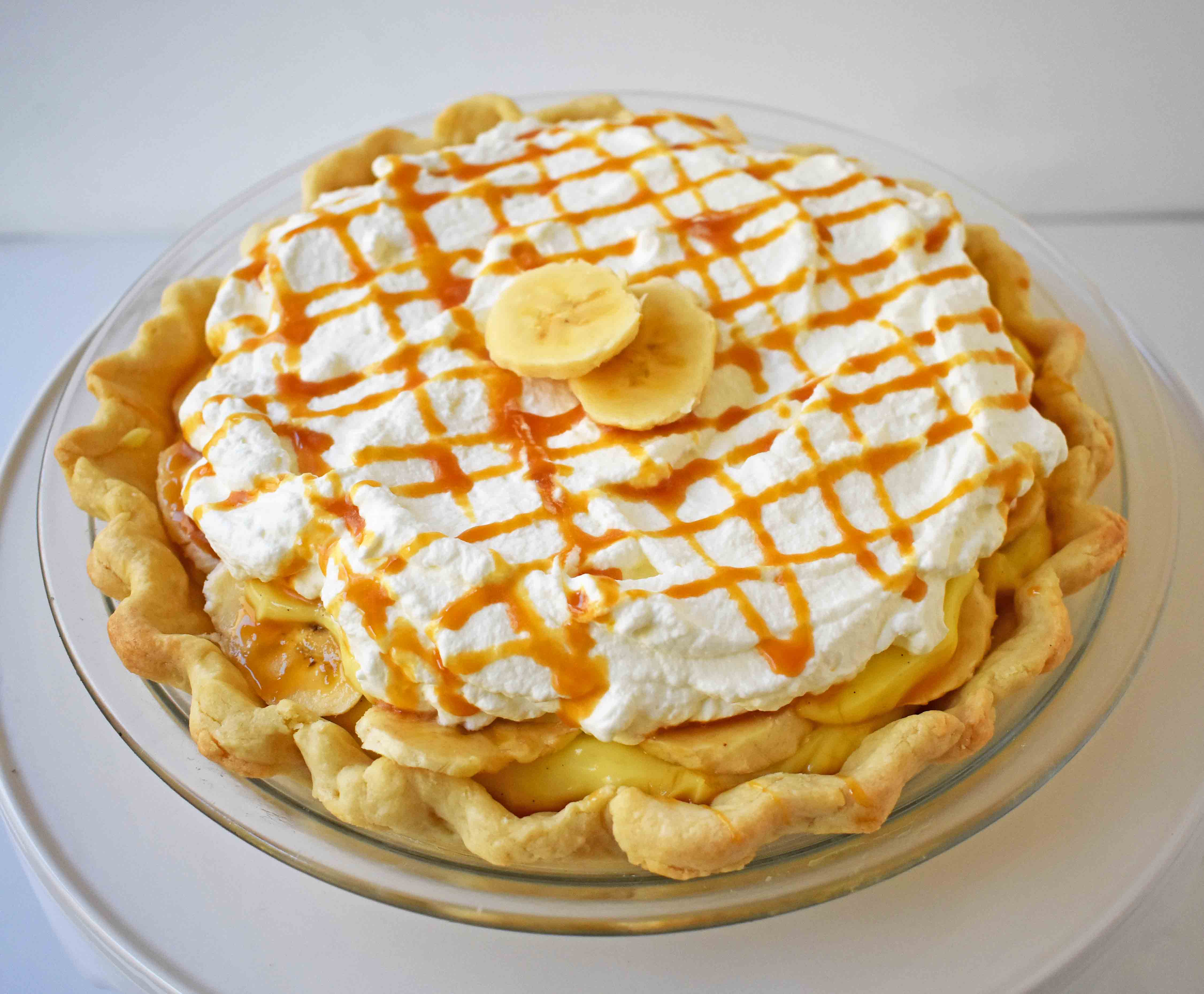 Salted Caramel Banana Cream Pie. Sweet Homemade Custard topped with fresh bananas, handcrafted salted caramel, and sweetened whipped cream all on a flaky, buttery crust.