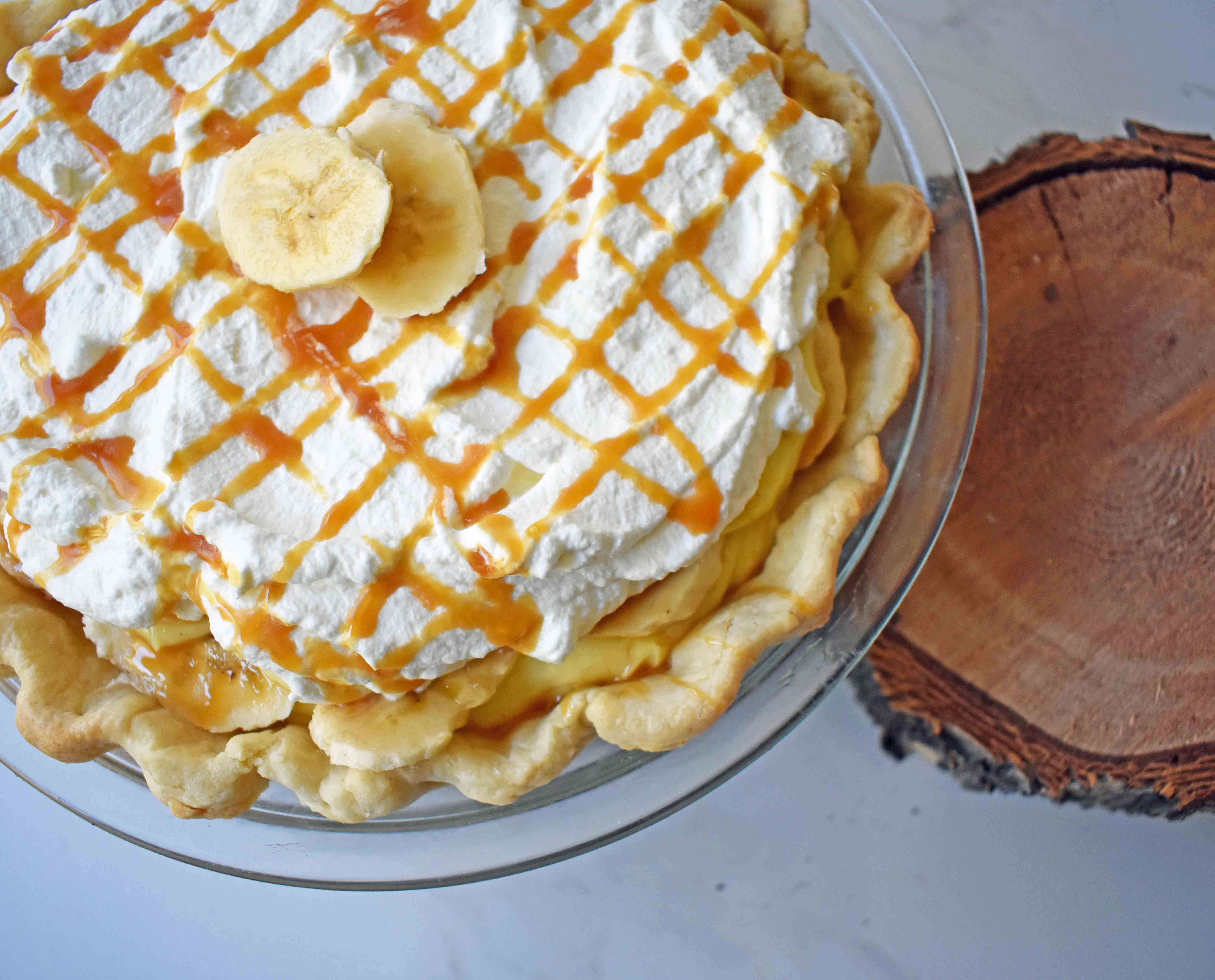 Salted Caramel Banana Cream Pie. Sweet Homemade Custard topped with fresh bananas, handcrafted salted caramel, and sweetened whipped cream all on a flaky, buttery crust. 