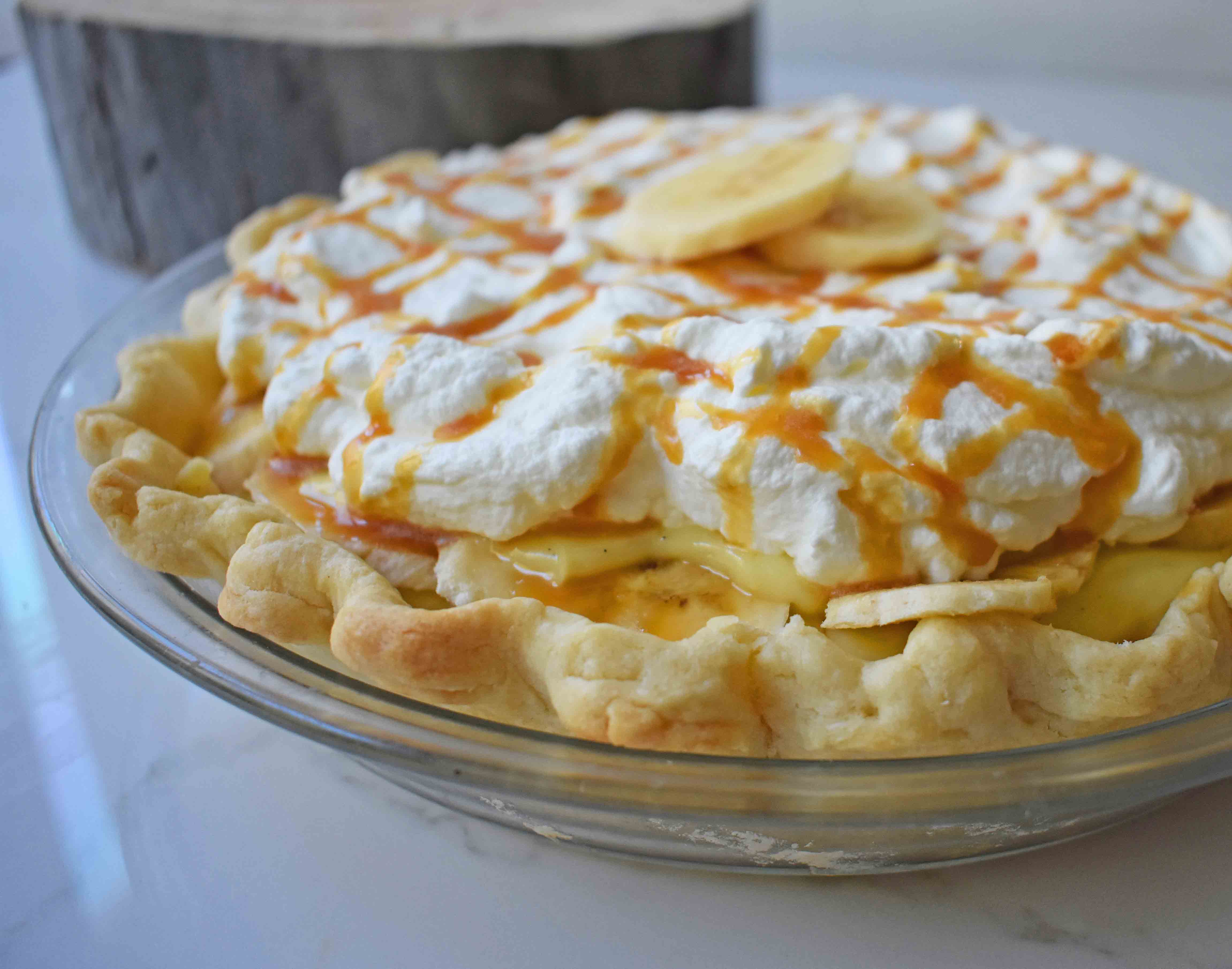 Salted Caramel Banana Cream Pie. Sweet Homemade Custard topped with fresh bananas, handcrafted salted caramel, and sweetened whipped cream all on a flaky, buttery crust. 