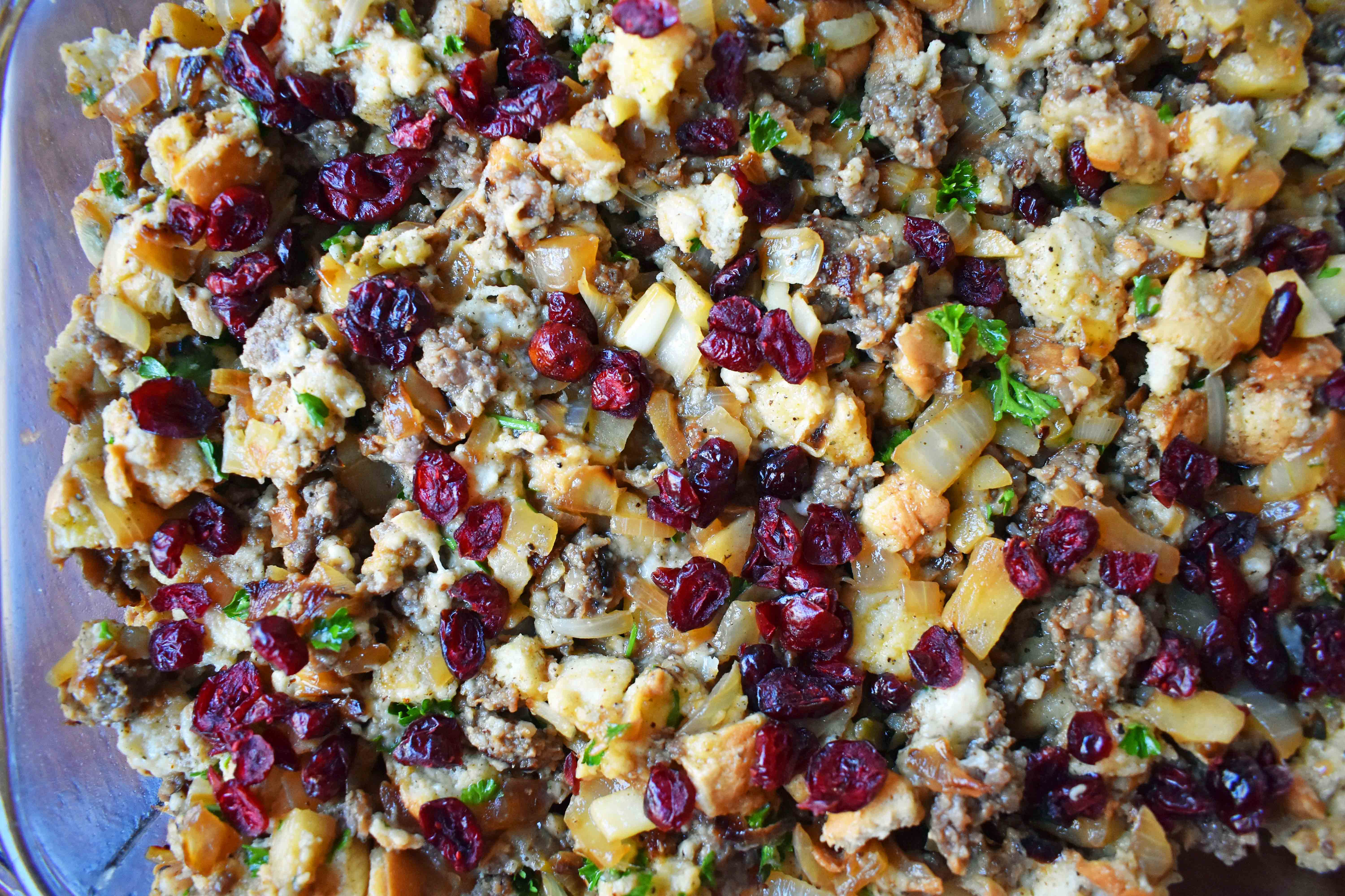 Cranberry Apple Sausage Stuffing by Modern Honey. Classic Bread Stuffing with Sausage, Dried Cranberries, and Crisp Apples. The perfect Thanksgiving side dish recipe!