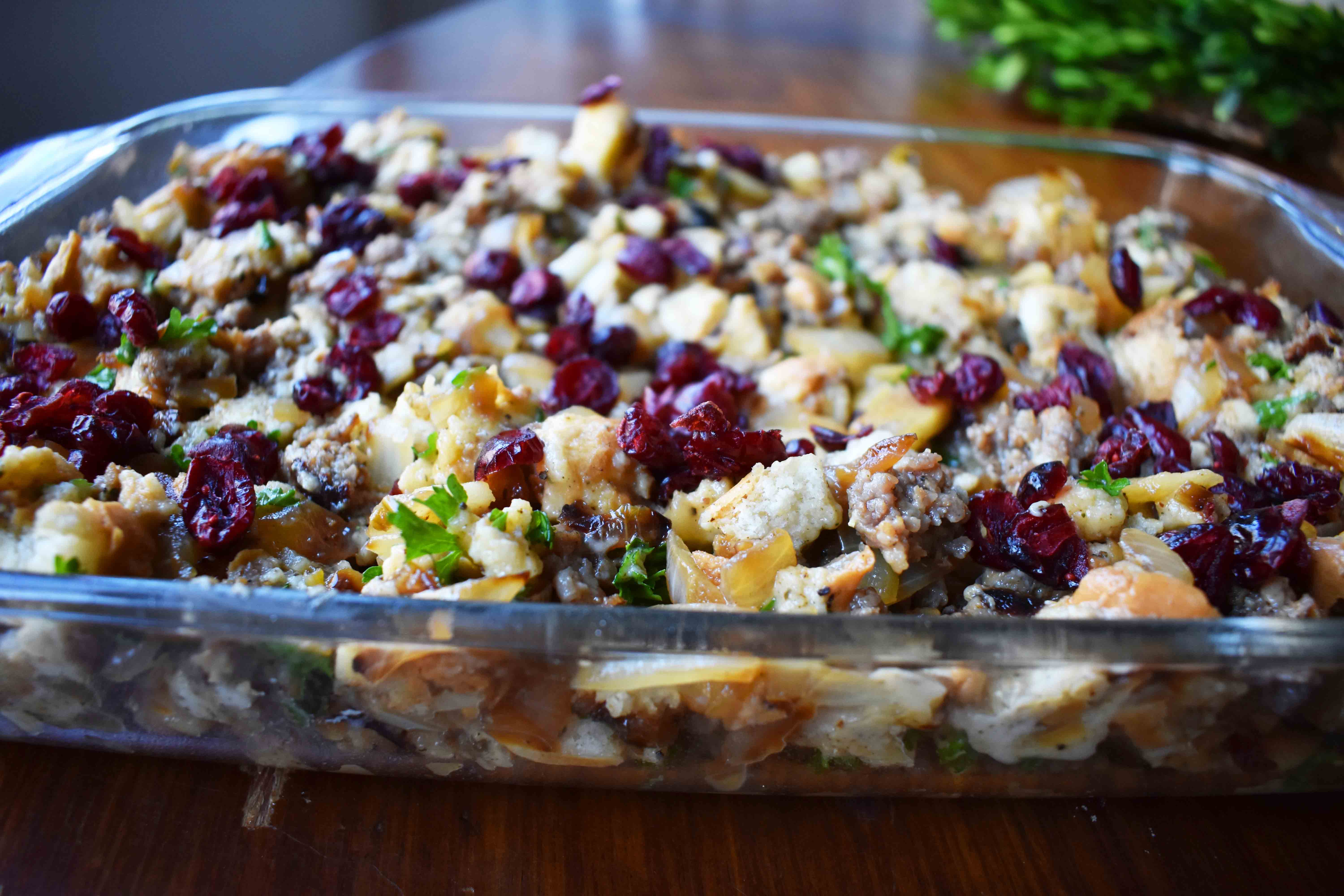 Cranberry Apple Sausage Stuffing by Modern Honey. Classic Bread Stuffing with Sausage, Dried Cranberries, and Crisp Apples. The perfect Thanksgiving side dish recipe!