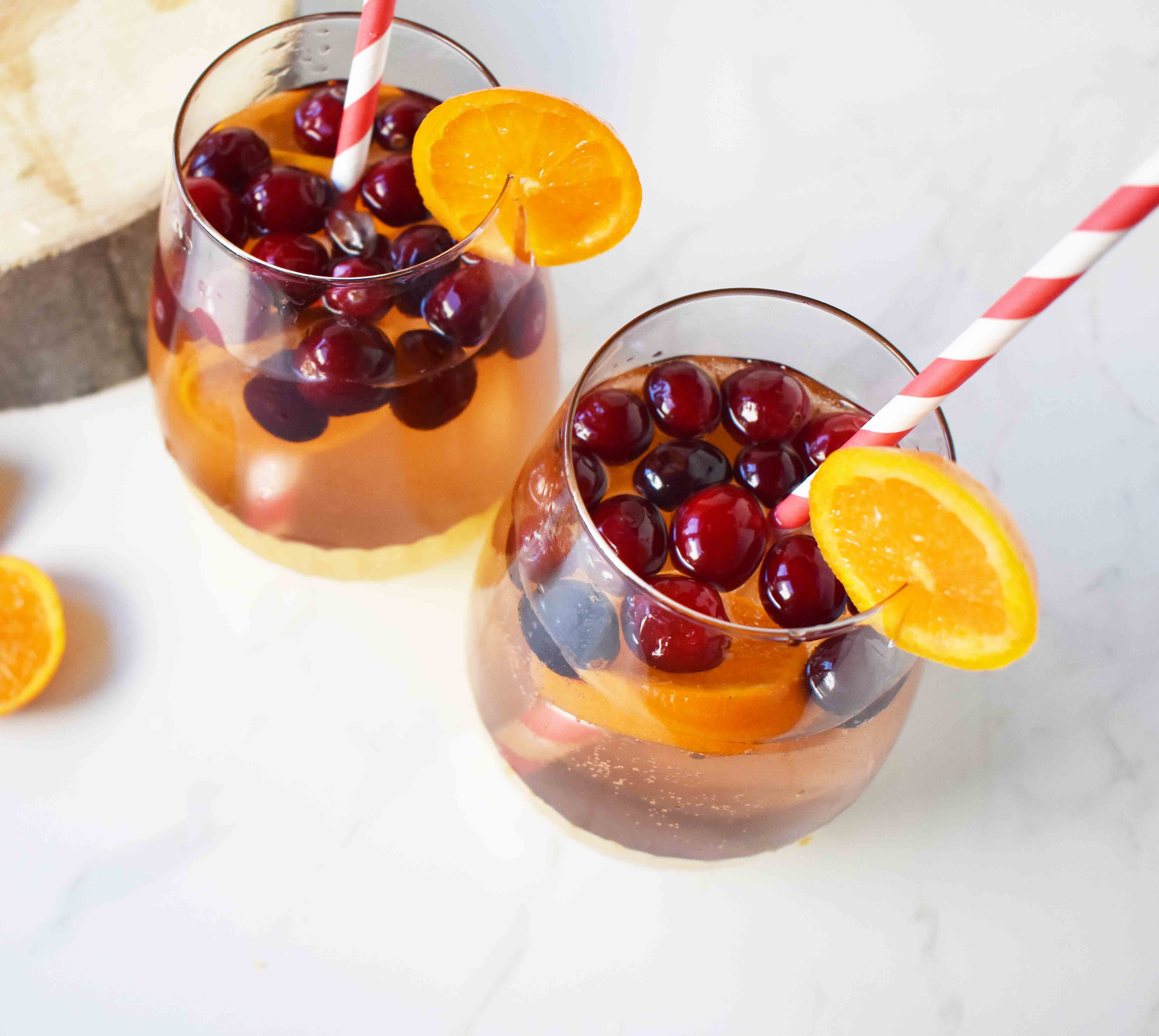 "The Henry" Cranberry Orange Mocktail by Modern Honey. Cranberry Sprite, Vanilla, Fresh Oranges and Cranberries. A perfect non-alcoholic party drink. 