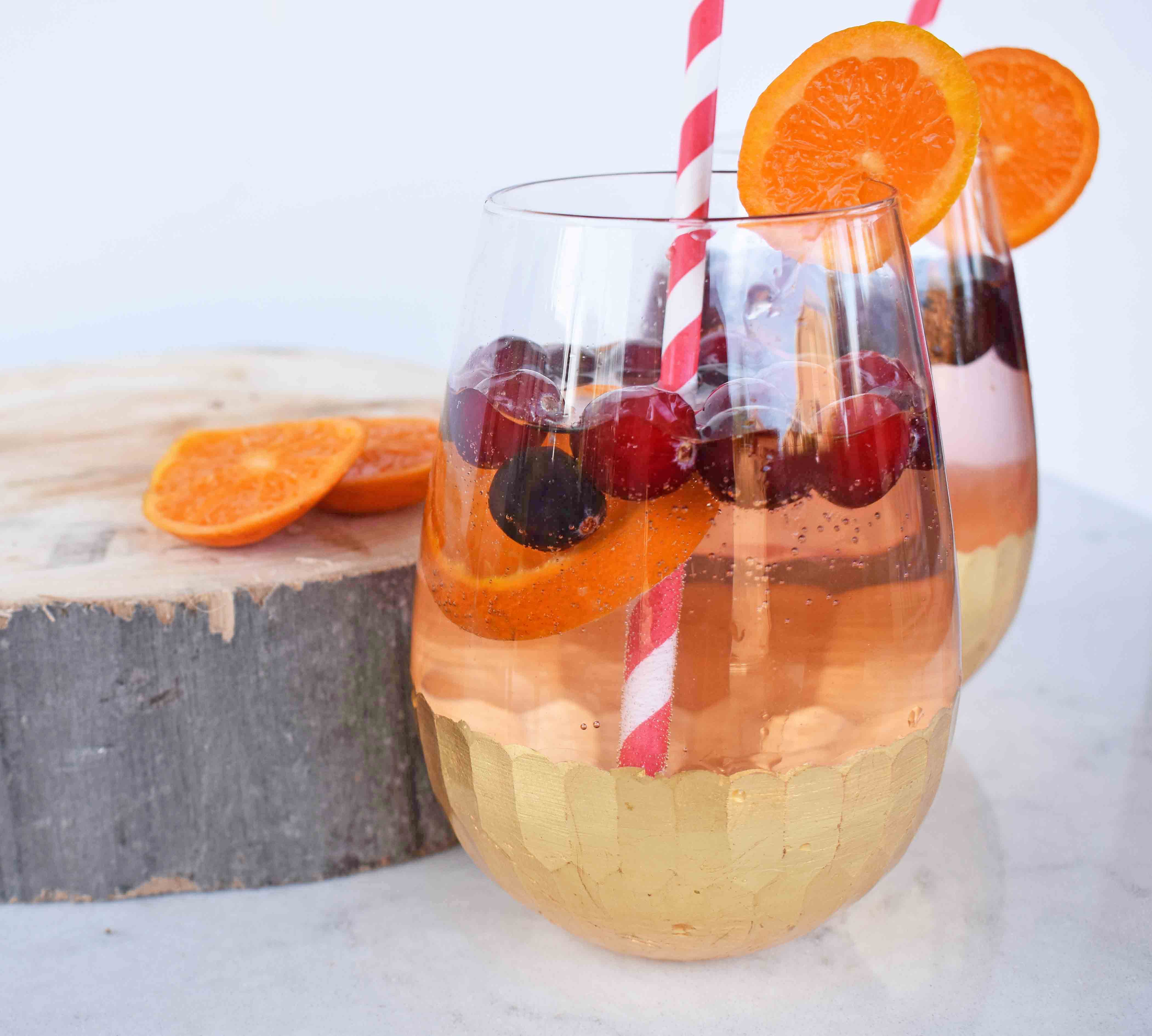 "The Henry" Cranberry Orange Mocktail by Modern Honey. Cranberry Sprite, Vanilla, Fresh Oranges and Cranberries. A perfect non-alcoholic party drink. 