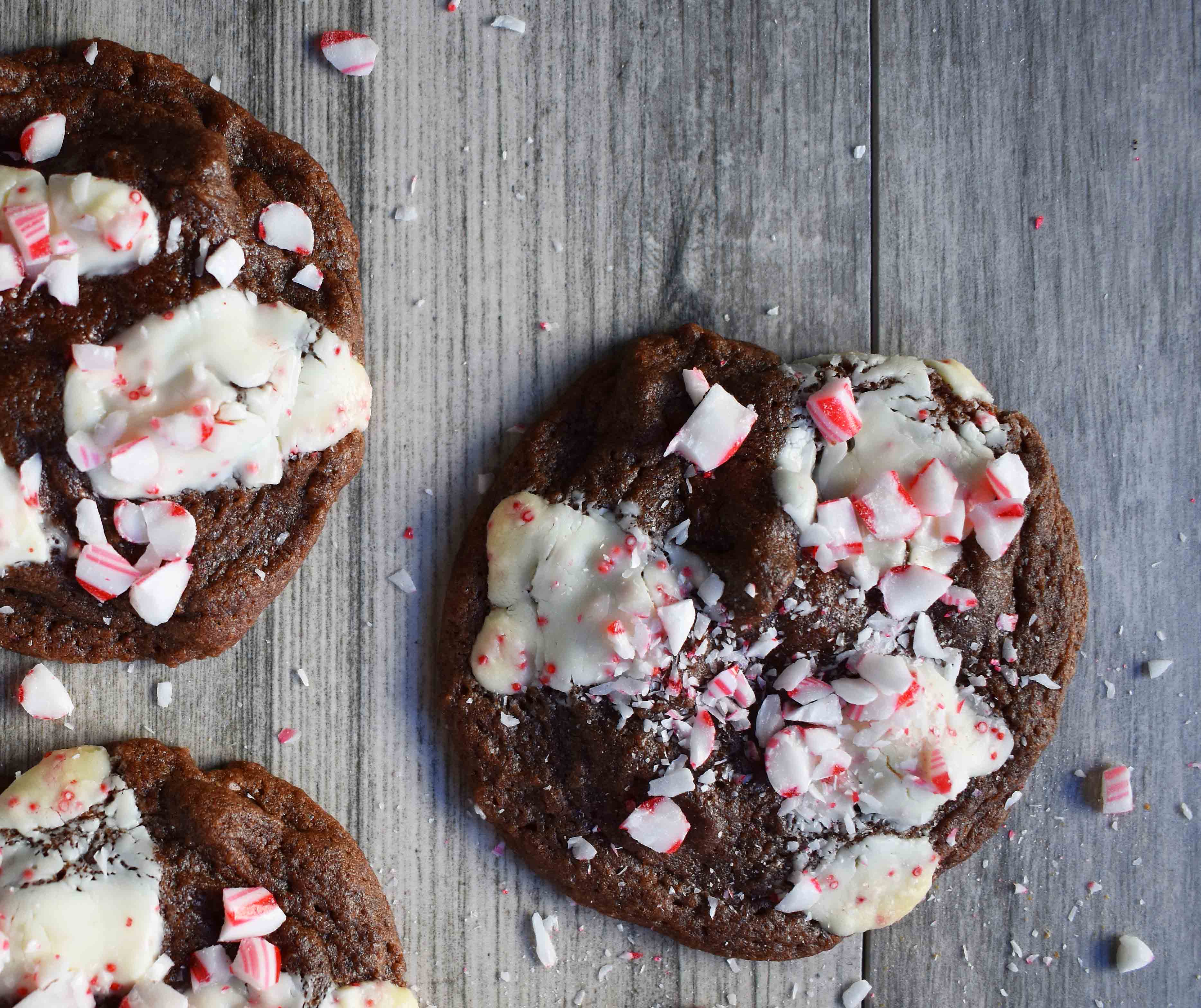 Mrs. Claus Chocolate Peppermint Cookies by Modern Honey. Rich chocolate chunks cookies with peppermint bark and candy canes. The most popular Christmas cookie!