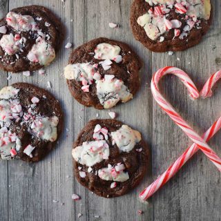 Mrs. Claus Chocolate Peppermint Cookies by Modern Honey. Rich chocolate chunks cookies with peppermint bark and candy canes. The most popular Christmas cookie!