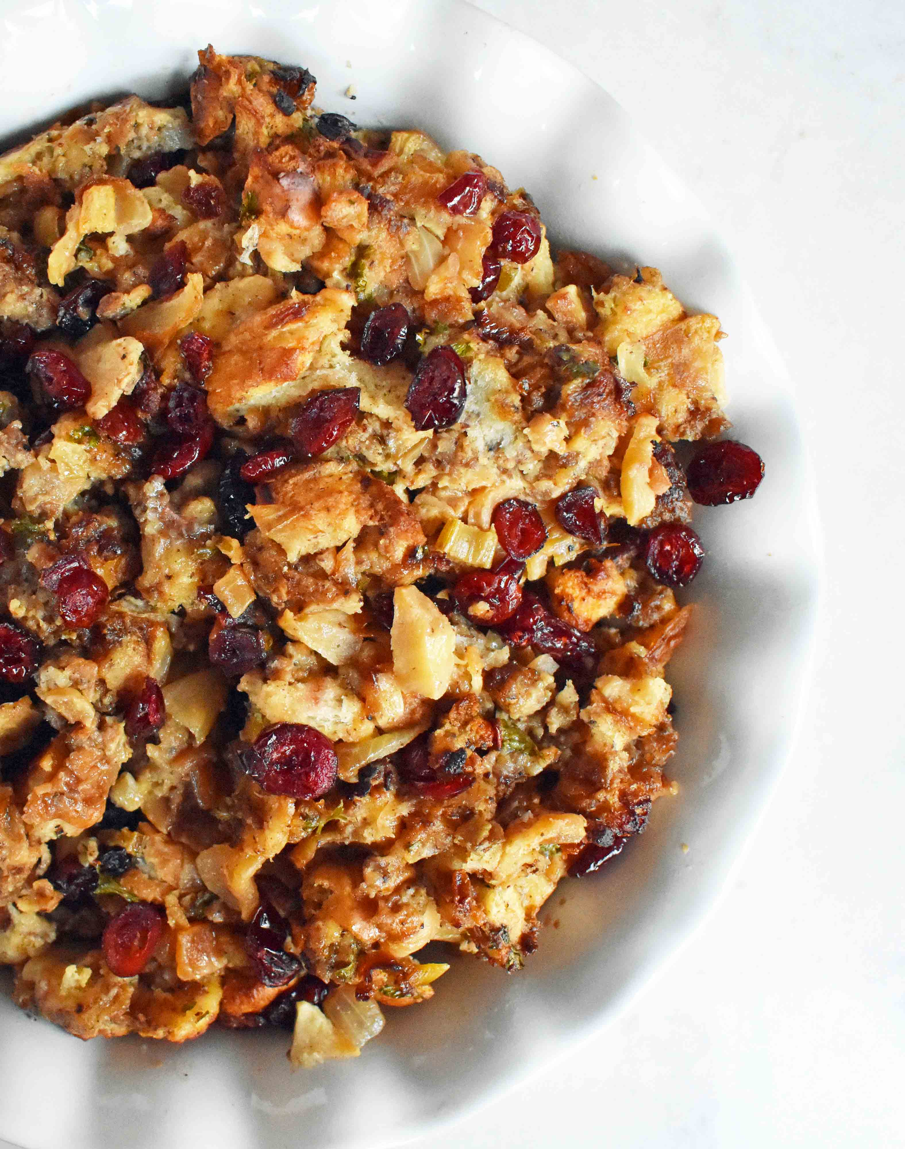 Cranberry Apple Sausage Stuffing by Modern Honey. Classic Bread Stuffing with Sausage, Dried Cranberries, and Crisp Apples. The perfect Thanksgiving side dish recipe!
