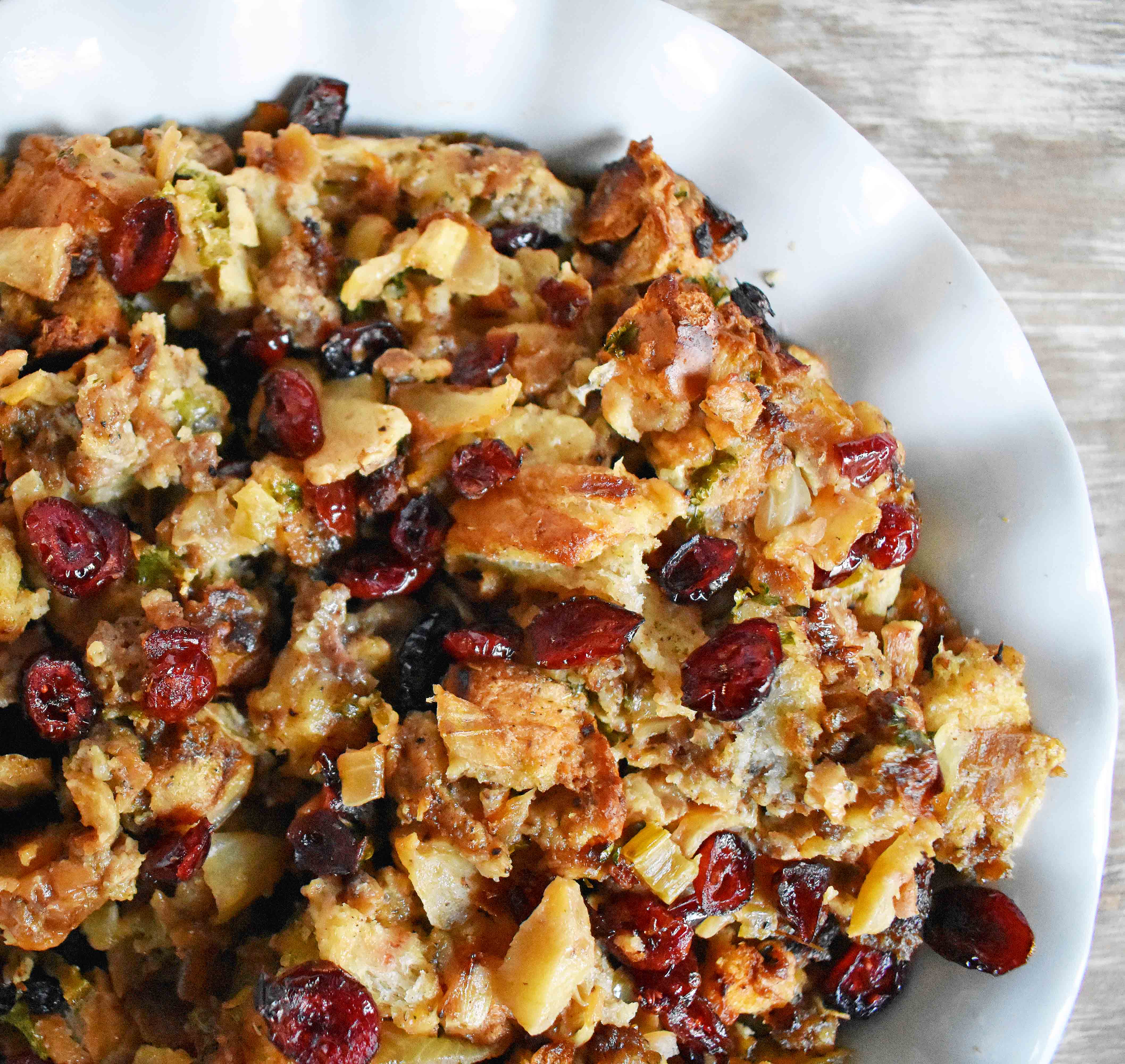 Cranberry Apple Sausage Stuffing by Modern Honey. Classic Bread Stuffing with Sausage, Dried Cranberries, and Crisp Apples. The perfect Thanksgiving side dish recipe!