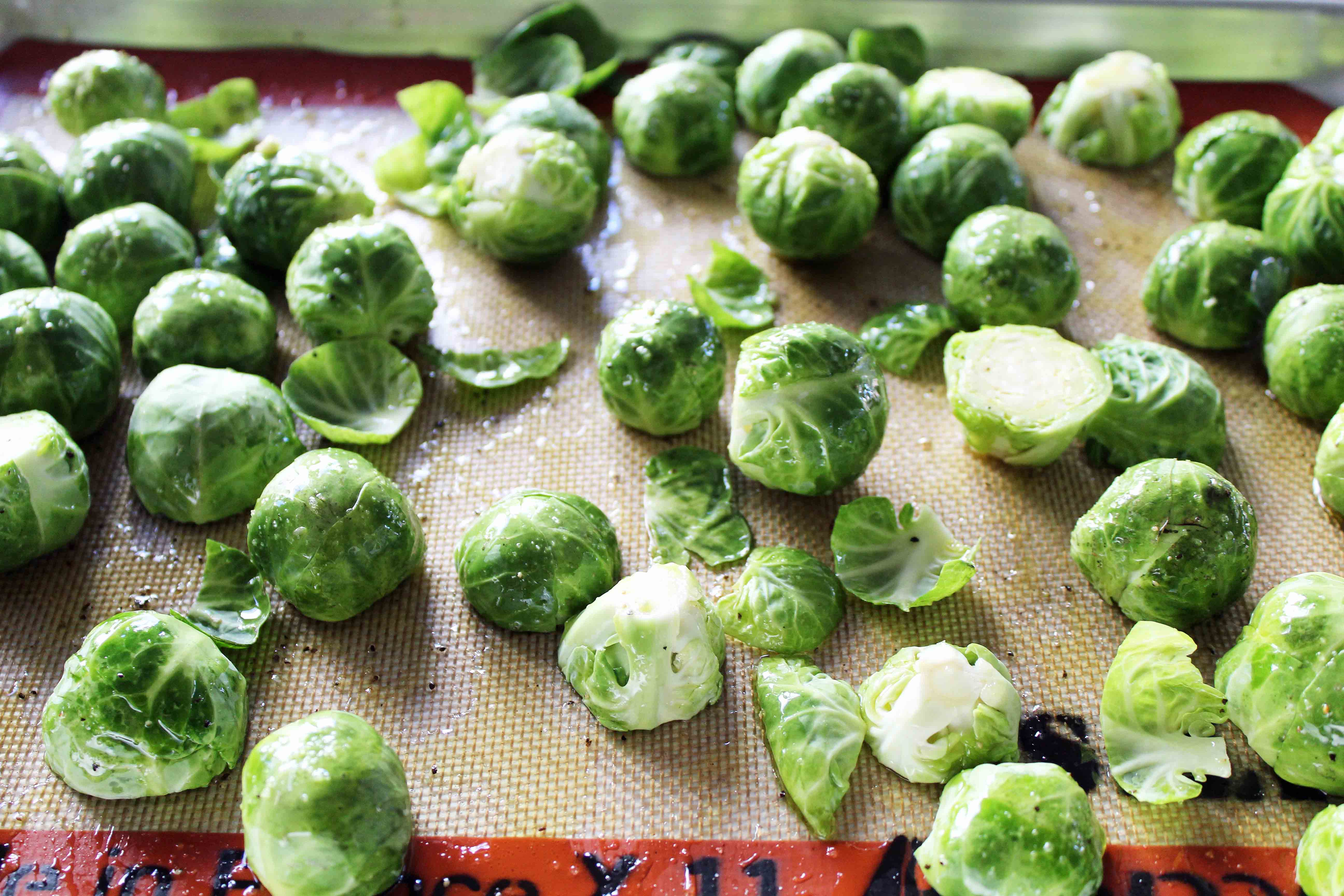 Bacon Roasted Brussels Sprouts with Pomegranates by Modern Honey. Roasted Brussels Sprouts in Extra Virgin Olive Oil, Crispy Bacon, Pomegranates, and Hazelnuts. The perfect healthy Thanksgiving side dish.