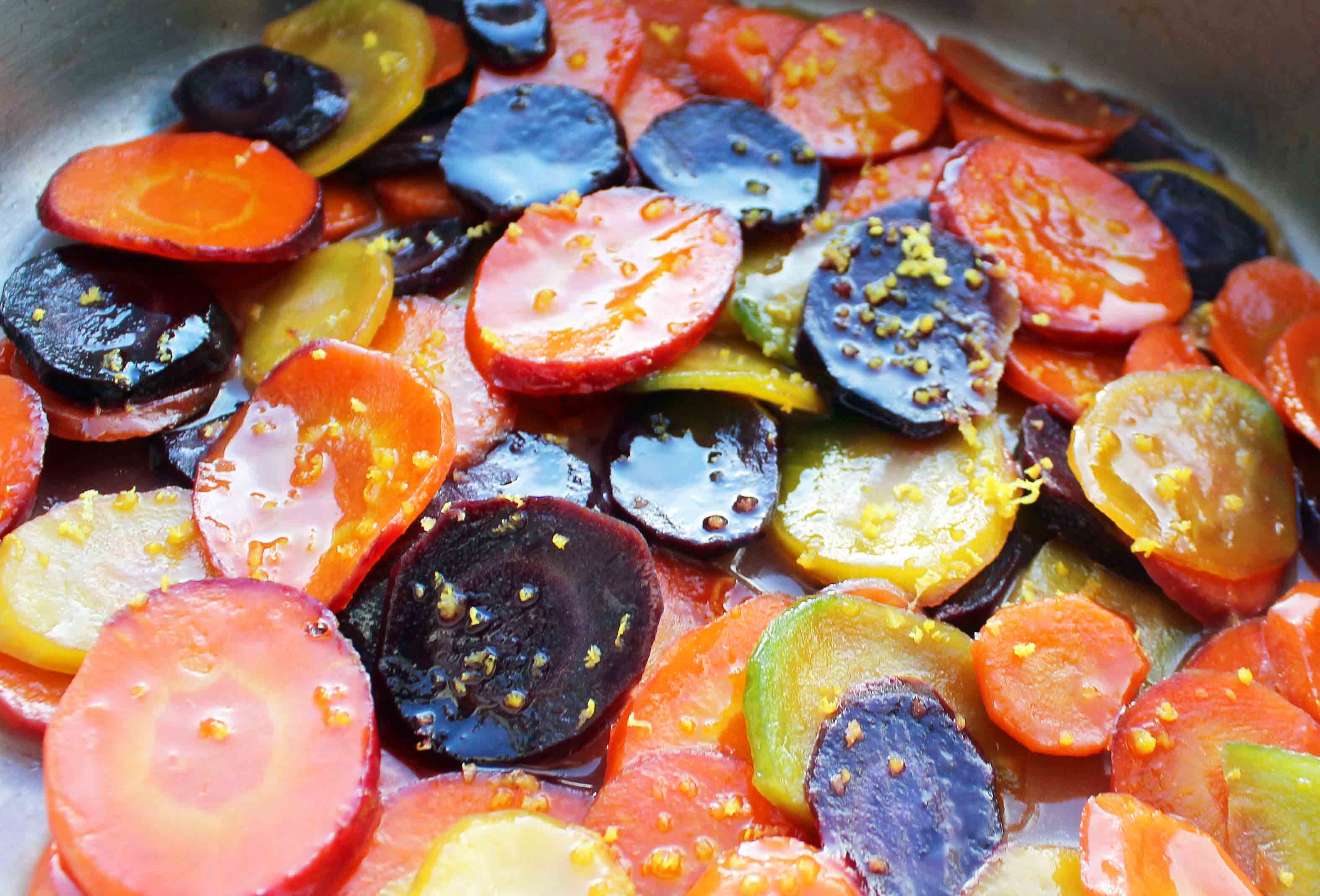 Honey Butter Glazed Carrots by Modern Honey. Heirloom Carrots, Sweet Cream Butter, Creamy Honey, and Lemon Zest make these carrots a real crowd pleaser. A simple but flavorful side dish.