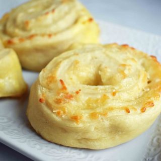 Golden's Garlic Parmesan Cheese Rolls by Modern Honey. Made with 5 simple ingredients -- pizza dough, butter, garlic powder, parmesan and mozzarella cheese.