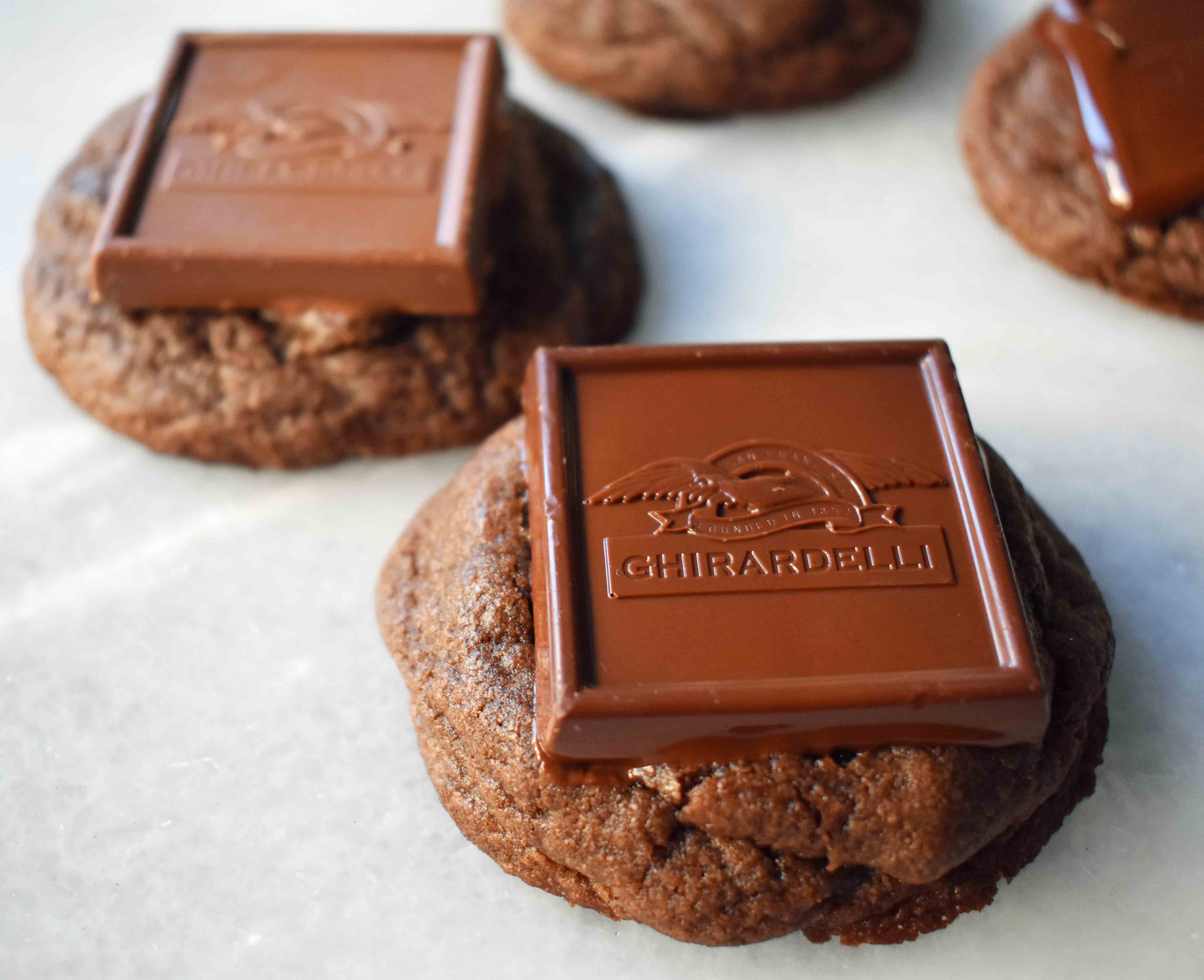 Ghirardelli Squares Chocolate Cookies. Double Chocolate Cookies topped with a creamy Ghirardelli square chocolate. Milk Chocolate Caramel, Dark Chocolate Mint,or Peppermint Bark Ghirardelli Squares are placed on top of this decadent cookie. A crowd favorite!