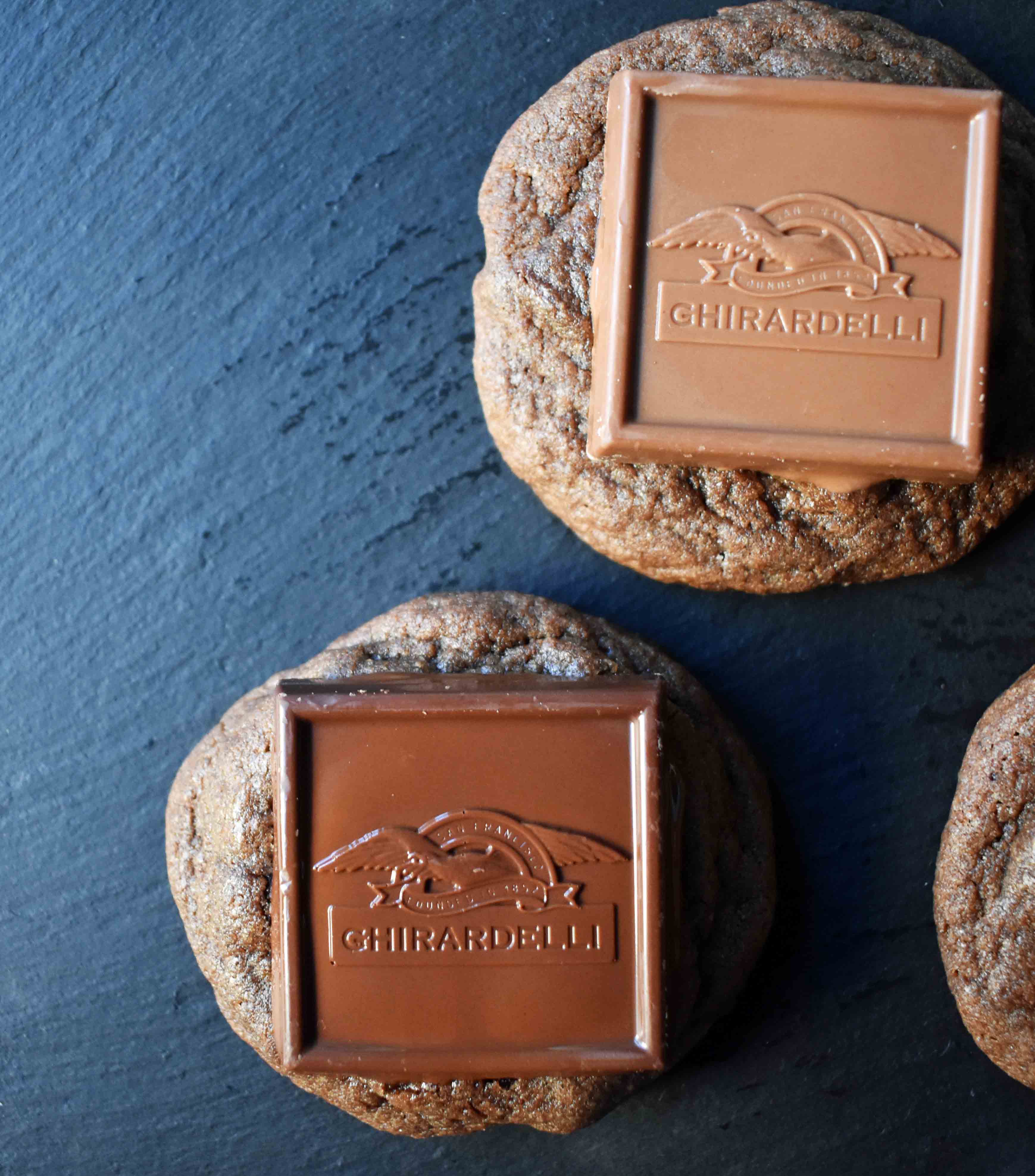 Ghirardelli Squares Chocolate Cookies. Double Chocolate Cookies topped with a creamy Ghirardelli square chocolate. Milk Chocolate Caramel, Dark Chocolate Mint,or Peppermint Bark Ghirardelli Squares are placed on top of this decadent cookie. A crowd favorite!