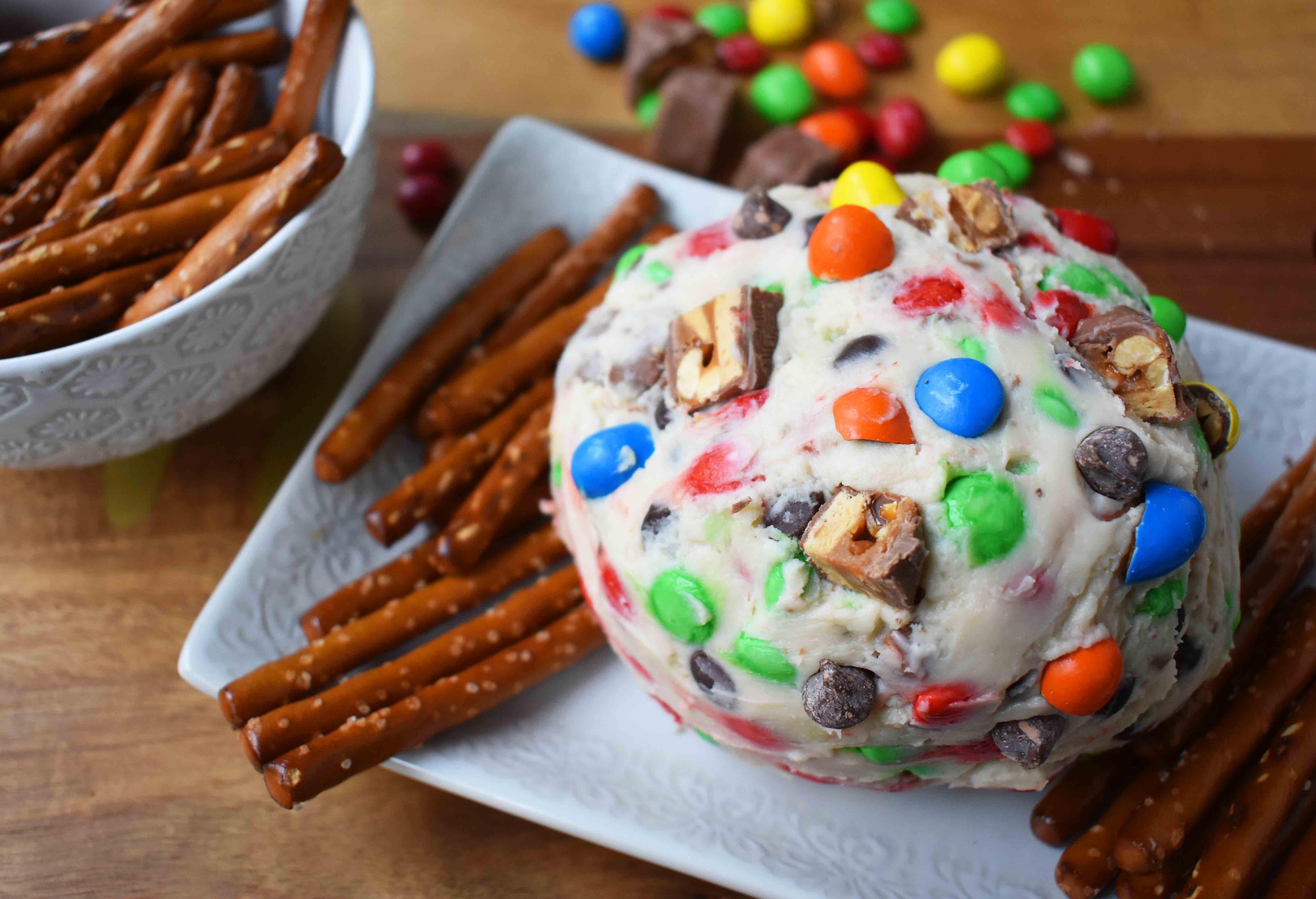 Chocolate Candy Bar Cheese Ball by Modern Honey. A popular sweet cheese ball that is perfect for parties. Dip pretzels in sweet candy bar dip. 
