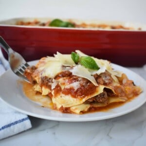 Italian Bolognese Lasagna. Authentic Italian recipe made with a traditional meat sauce, a creamy bechamel sauce, parmesan and mozzarella cheeses.