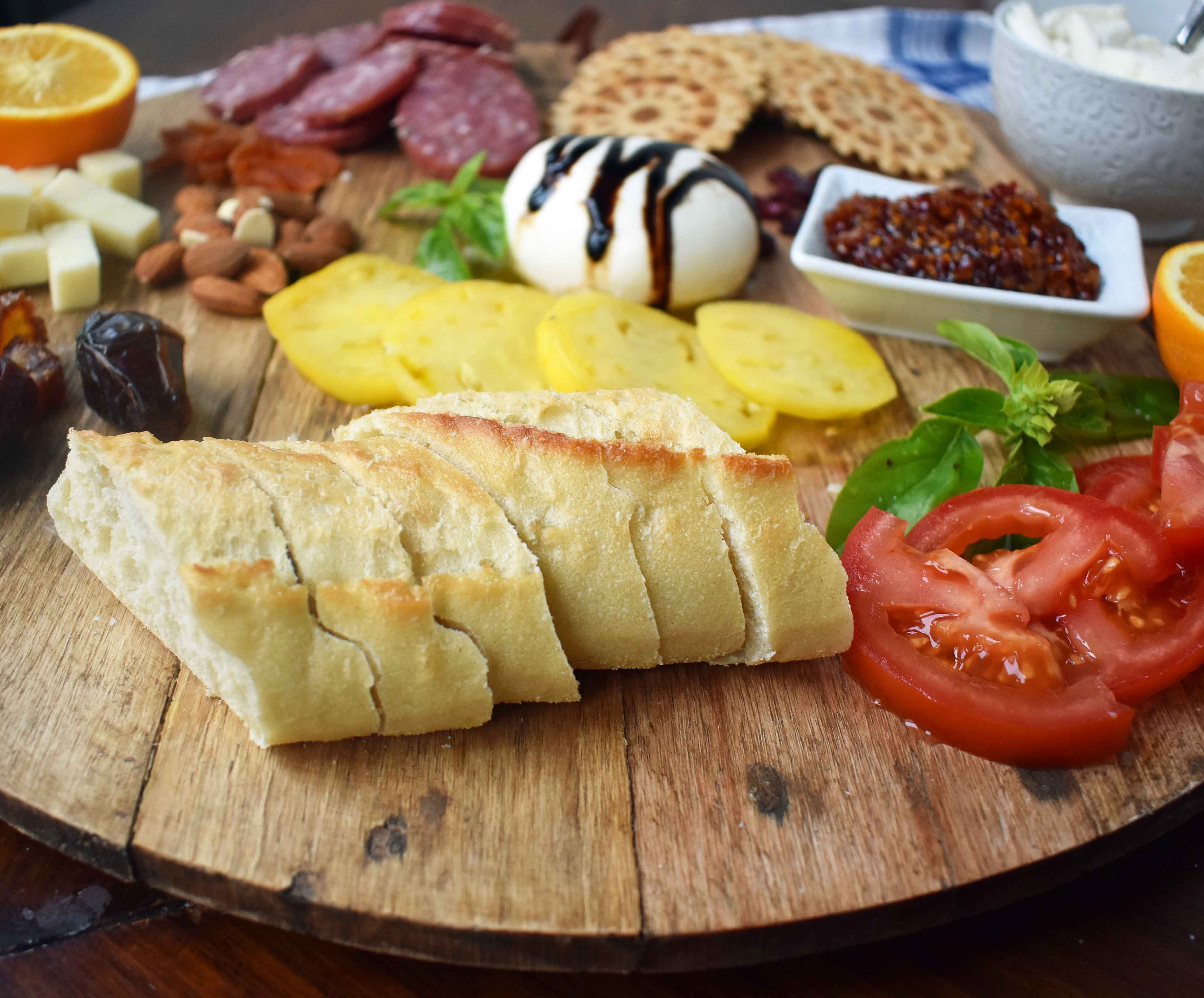 Ultimate Bruschetta Bar by Modern Honey. How to make a perfect bruschetta or charcuterie board using fresh meats, cheeses, fruits, breads, nuts, roasted vegetables, and fresh herbs. It's the perfect party appetizer. Bruschetta topping ideas plus flavor combinations. 