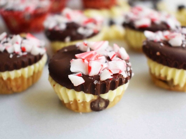 Peppermint Bark Cookie Dough Cups by Modern Honey. Egg Free Chocolate Chip Cookie Dough layered with white chocolate and semisweet chocolate and topped with crushed candy canes.